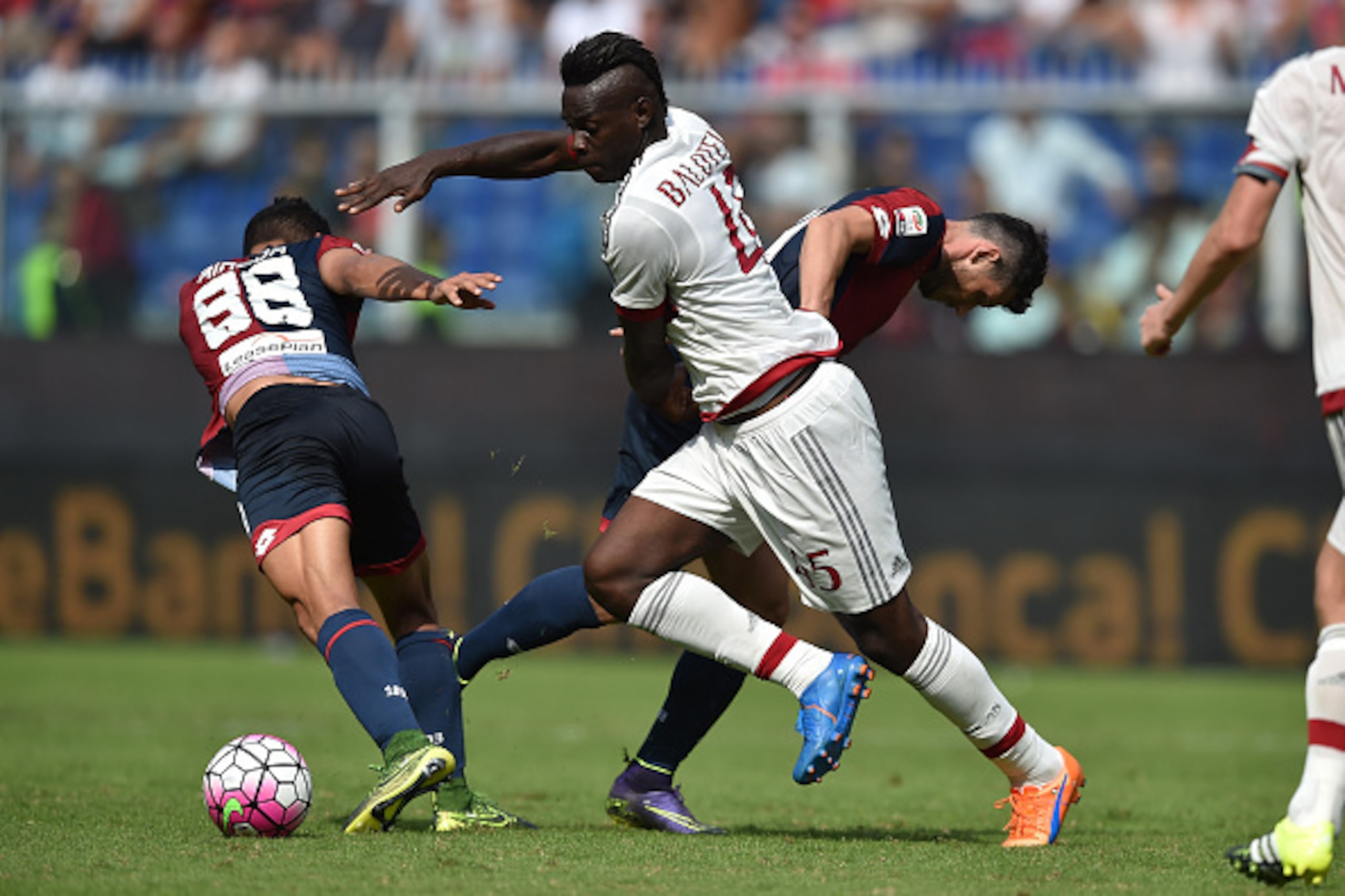 GENOA, ITALY - SEPTEMBER 27:  Mario Balotelli (C) of AC Milan is challenged by Tomas Rincon (L) and Blerin Dzemaili of Genoa CFC during the Serie A match between Genoa CFC and AC Milan at Stadio Luigi Ferraris on September 27, 2015 in Genoa, Italy.  (Phot