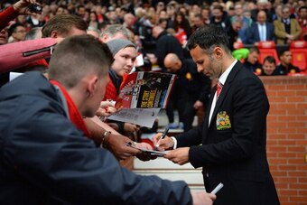MANCHESTER, ENGLAND - APRIL 26:  Ryan Giggs of Manchester United signs autographs during the Barclays Premier League match between Manchester United and Norwich City at Old Trafford on April 26, 2014 in Manchester, England.  (Photo by Laurence Griffiths/G