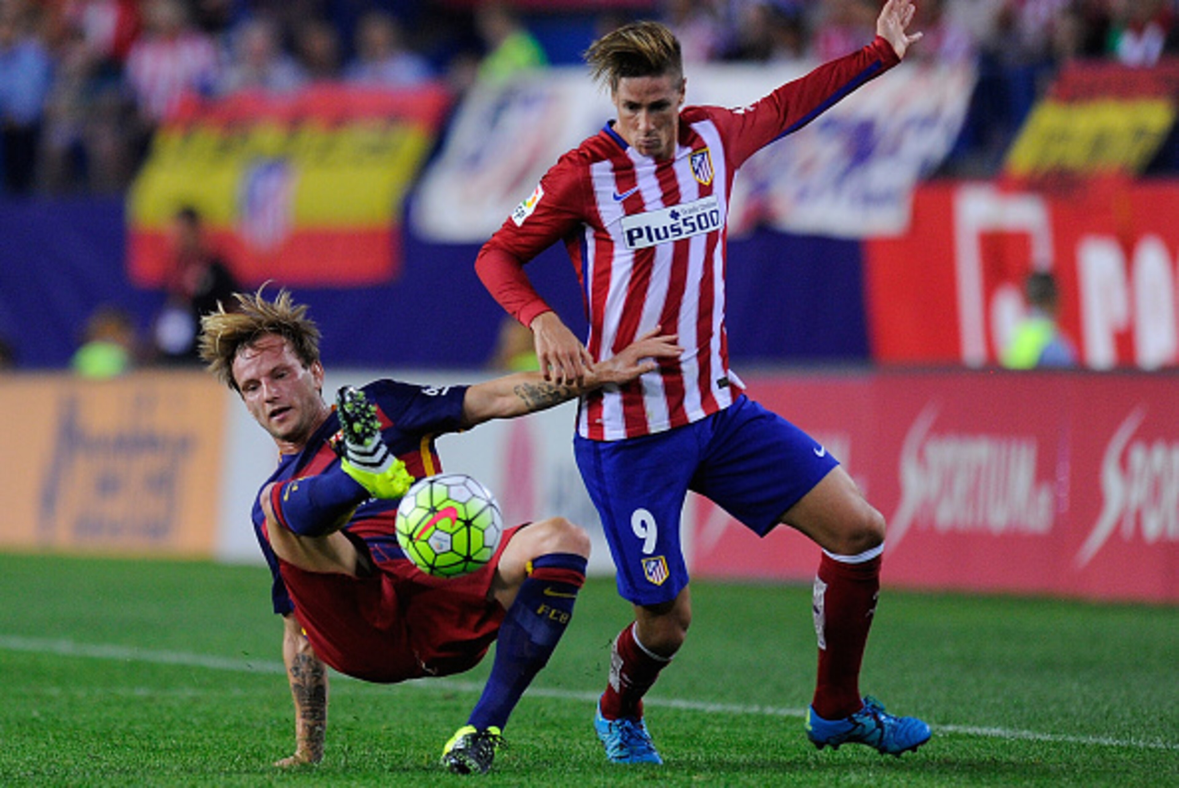 MADRID, SPAIN - SEPTEMBER 12: Fernando Torres of Club Atletico de Madrid is tackled by Ivan Rakitic of FC Barcelona during the La Liga match between Club Atletico de Madrid and FC Barcelona at Vicente Calderon Stadium on September 12, 2015 in Madrid, Spa MADRID, SPAIN - SEPTEMBER 12: Fernando Torres of Club Atletico de Madrid is tackled by Ivan Rakitic of FC Barcelona during the La Liga match between Club Atletico de Madrid and FC Barcelona at Vicente Calderon Stadium on September 12, 2015 in Madrid, Spa