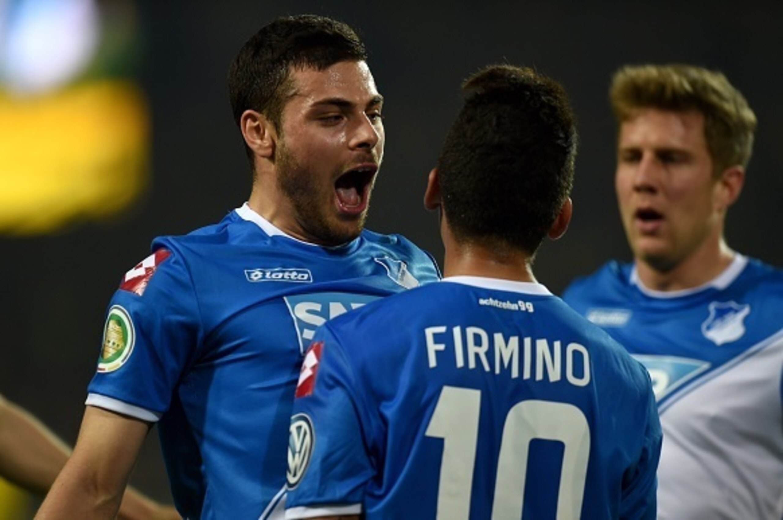 Hoffenheim's Brazilian midfielder Roberto Firmino (front) and his teammates celebrate during the German Football Cup DFB Pokal quarter-final match between Borussia Dortmund and 1899 Hoffenheim in Dortmund, western Germany, on April 7, 2015. AFP PHOTO / PA