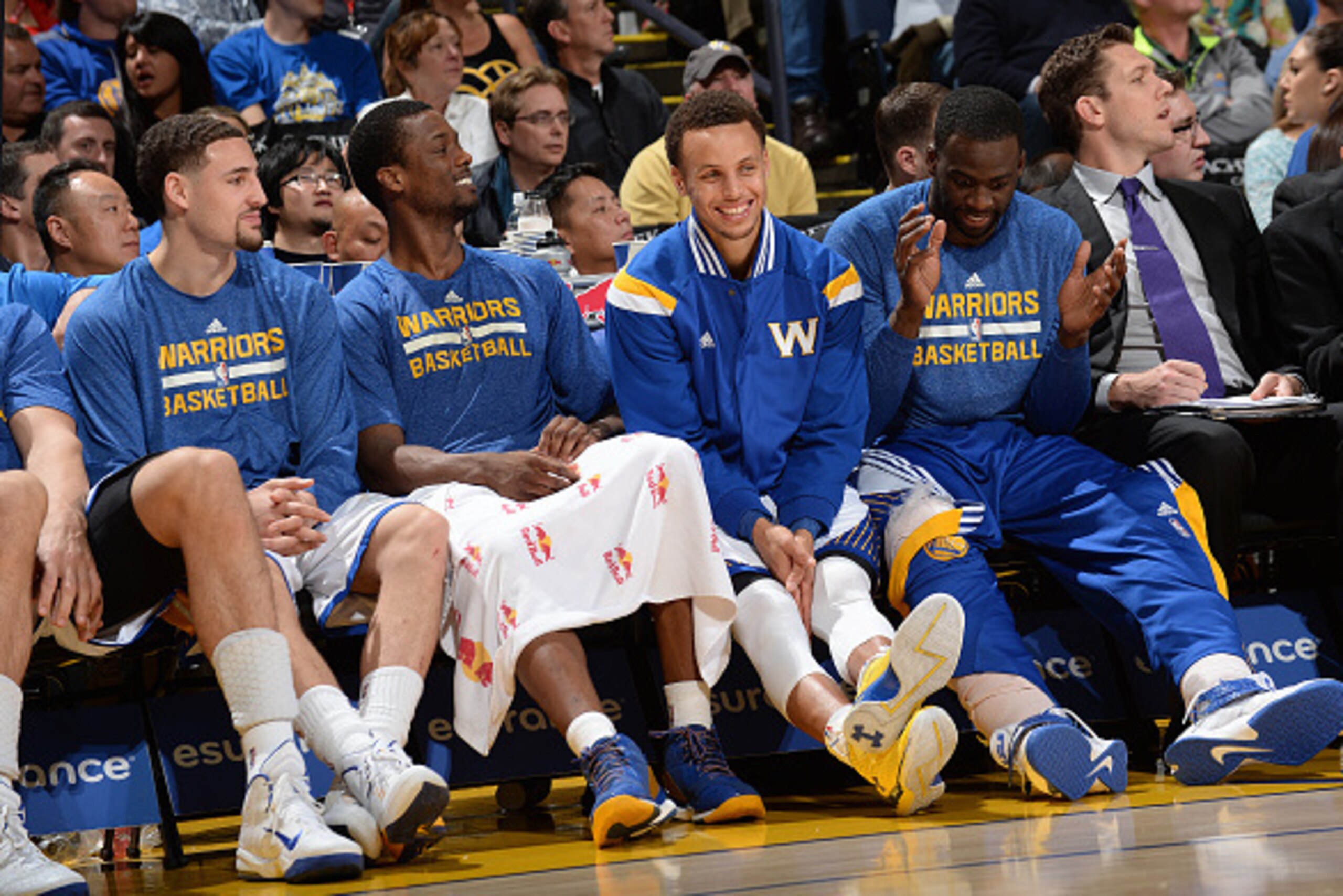 OAKLAND, CA - APRIL 15: Klay Thompson #11, Harrison Barnes #40, Stephen Curry #30, and Draymond Green #23 of the Golden State Warriors sit on the sideline during a game against the Denver Nuggets on April 15, 2015 at Oracle Arena in Oakland, California. N