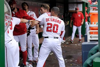 WASHINGTON, DC - SEPTEMBER 27: Bryce Harper #34 of the Washington Nationals is pulled away by Ian Desmond #20 after an altercation with Jonathan Papelbon #58 (not pictured) in the eighth inning against the Philadelphia Phillies at Nationals Park on Septem