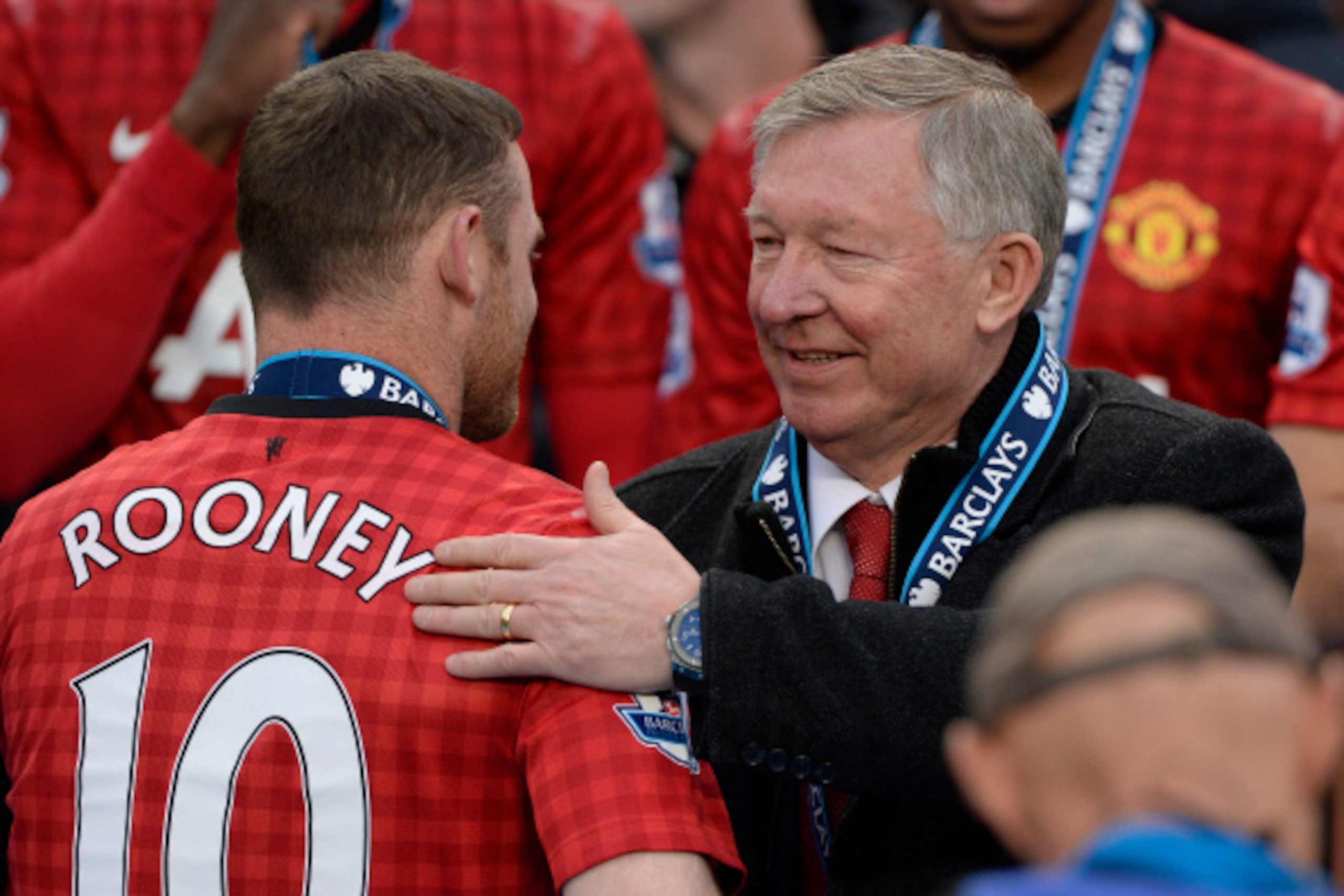 MANCHESTER, UNITED KINGDOM - MAY 12:  Sir Alex Ferguson pats Wayne Rooney on the back at the trophy presentation after the Manchester United versus Swansea City FA Premier League match, the final home game for Sir Alex Ferguson as United manager, at Old T