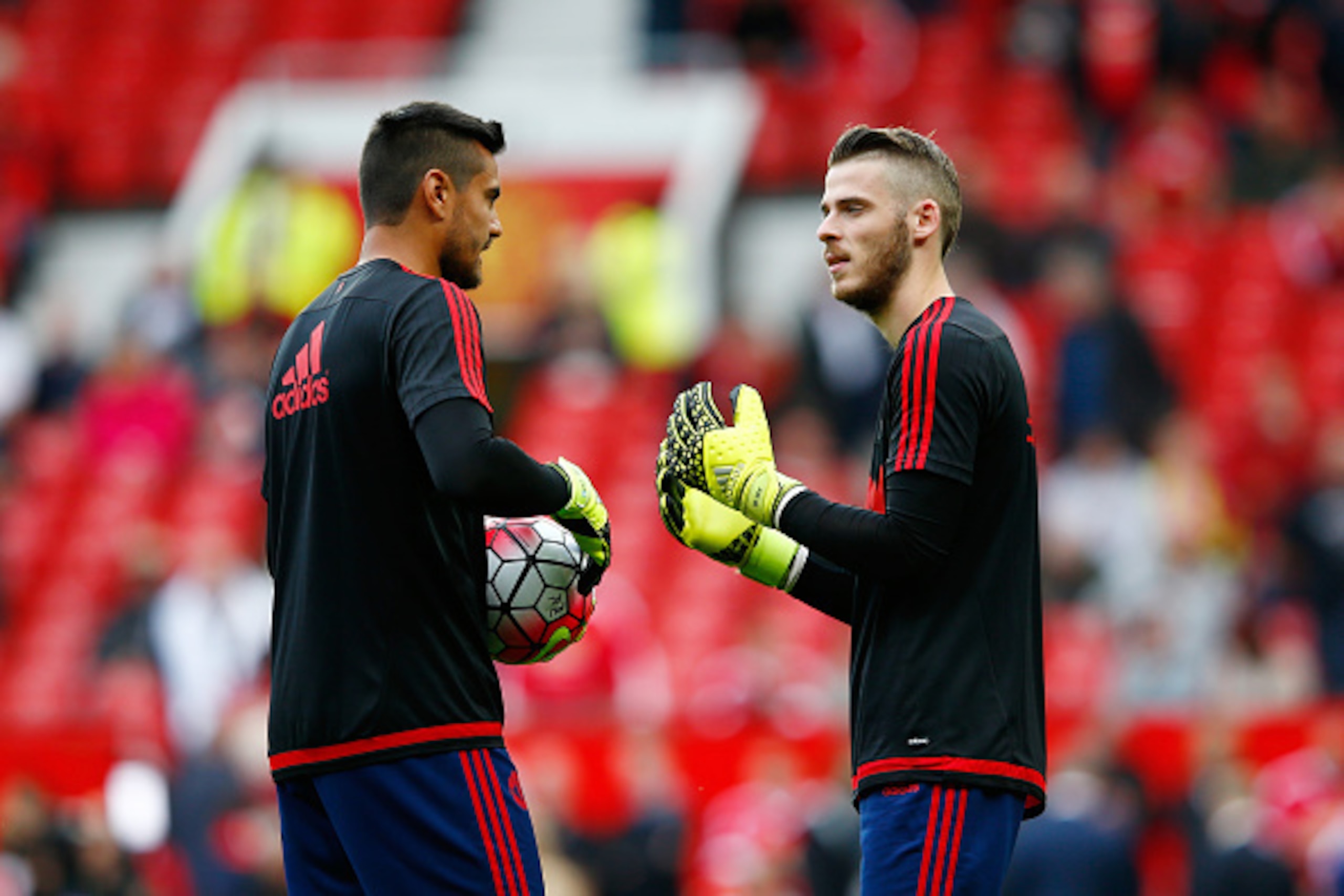 MANCHESTER, ENGLAND - SEPTEMBER 12:  David De Gea of Manchester United talks to Sergio Romero prior to the Barclays Premier League match between Manchester United and Liverpool at Old Trafford on September 12, 2015 in Manchester, United Kingdom.  (Photo b