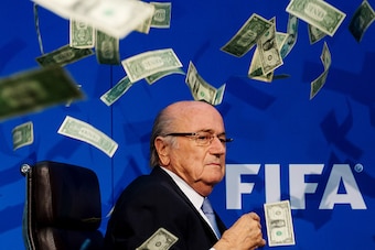 ZURICH, SWITZERLAND - JULY 20: Comedian Simon Brodkin (not pictured) throws dollar bills at FIFA President Joseph S. Blatter during a press conference at the Extraordinary FIFA Executive Committee Meeting at the FIFA headquarters on July 20, 2015 in Zuric