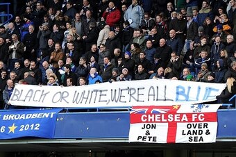 Chelsea fans hold an anti-racism banner during the English Premier League football match between Chelsea and Burnley at Stamford Bridge in London on February 21, 2015.  AFP PHOTO / OLLY GREENWOOD

RESTRICTED TO EDITORIAL USE. NO USE WITH UNAUTHORIZED AUDI
