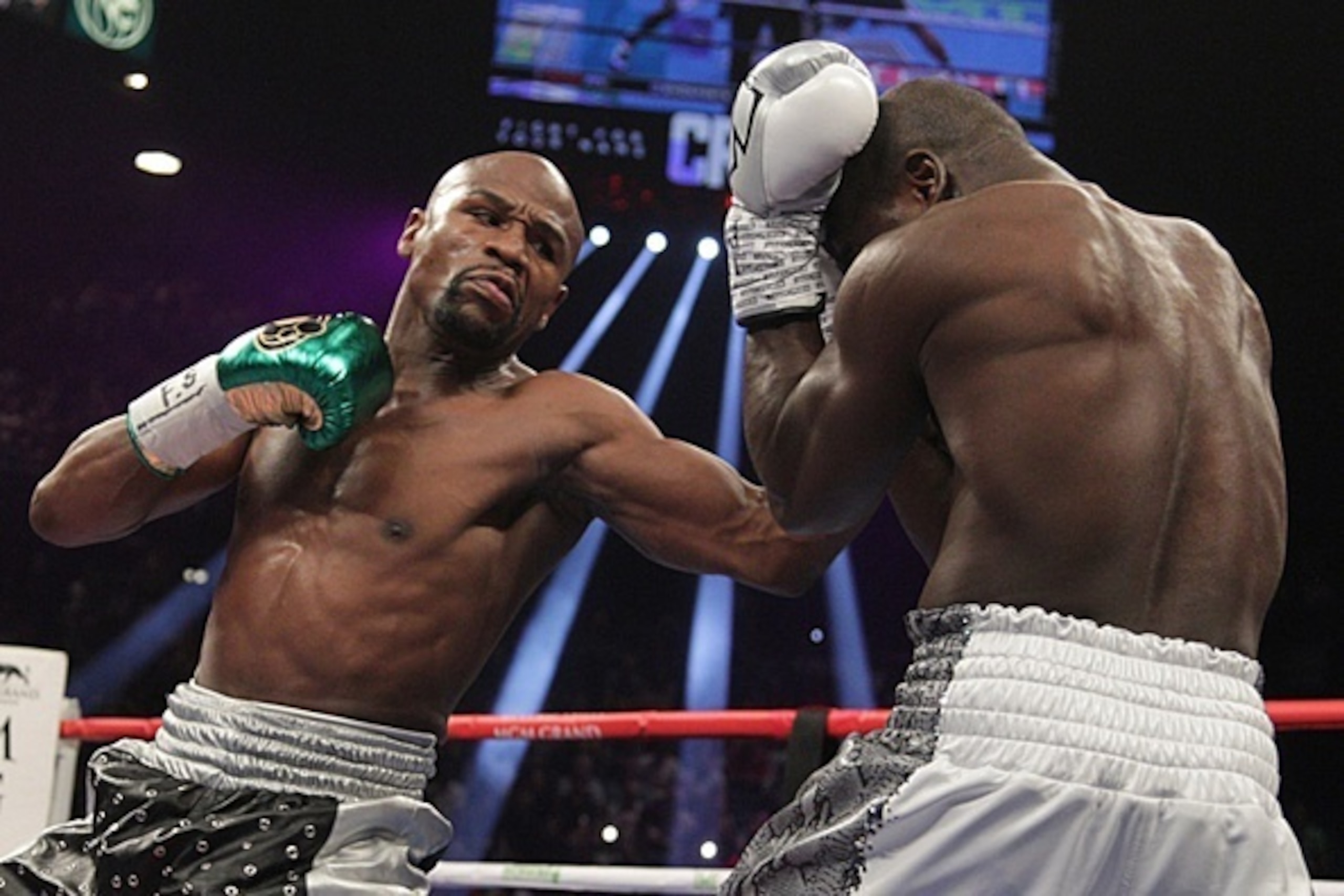Floyd Mayweather Jr. (L) lands on punch on Andre Berto during the fight for the WBO Welterweight World Title at the MGM Grand Garden Arena in Las Vegas, Nevada on September 12, 2015.  Floyd Mayweather earned a unanimous decision over Andre Berto to claim 
