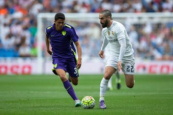 MADRID, SPAIN - SEPTEMBER 26: Isco (R) of Real Madrid CF competes for the ball with Pablo Fornals (L) of Malaga CF during the La Liga match between Real Madrid CF and Malaga CF at Estadio Santiago Bernabeu on September 26, 2015 in Madrid, Spain.  (Photo b