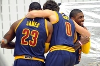 Sep 28, 2015; Cleveland, OH, USA; Cleveland Cavaliers forward LeBron James (23), Cleveland Cavaliers forward Kevin Love (0) and Cleveland Cavaliers guard Kyrie Irving (2) during Cleveland Cavaliers media day at Cleveland Clinic Courts. Mandatory Credit: K