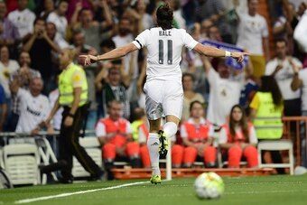 Real Madrid's Welsh forward Gareth Bale celebrates after scoring during the Spanish league football match Real Madrid CF vs Real Betis Balompie at the Santiago Bernabeu stadium in Madrid on August 29, 2015.   AFP PHOTO/ PIERRE-PHILIPPE MARCOU        (Phot