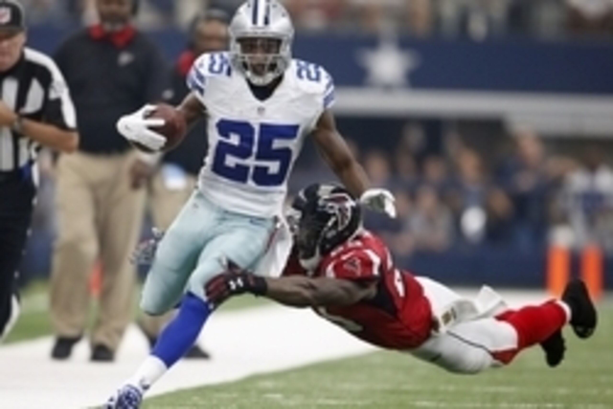 Sep 27, 2015; Arlington, TX, USA; Dallas Cowboys running back Joseph Randle (21) scores a first quarter touchdown against Atlanta Falcons safety William Moore (25) at AT&T Stadium. Mandatory Credit: Matthew Emmons-USA TODAY Sports