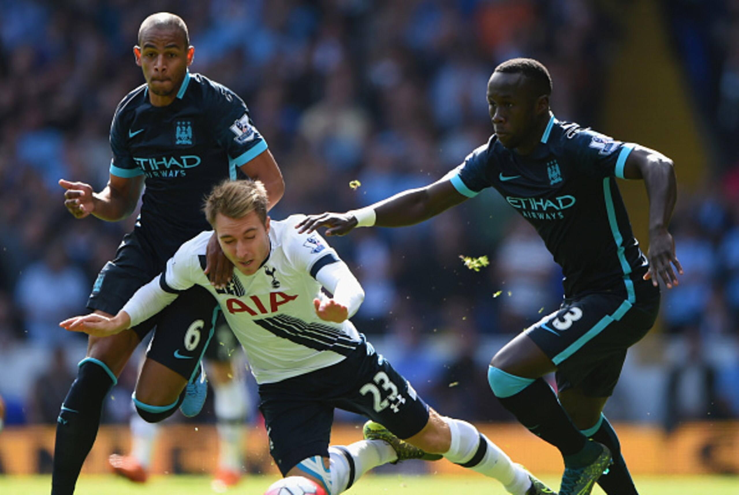 LONDON, ENGLAND - SEPTEMBER 26: Christian Eriksen (C) of Tottenham Hotspur is brought down by Fernando (L) and Bacary Sagna (R) of Manchester City  during the Barclays Premier League match between Tottenham Hotspur and Manchester City at White Hart Lane o