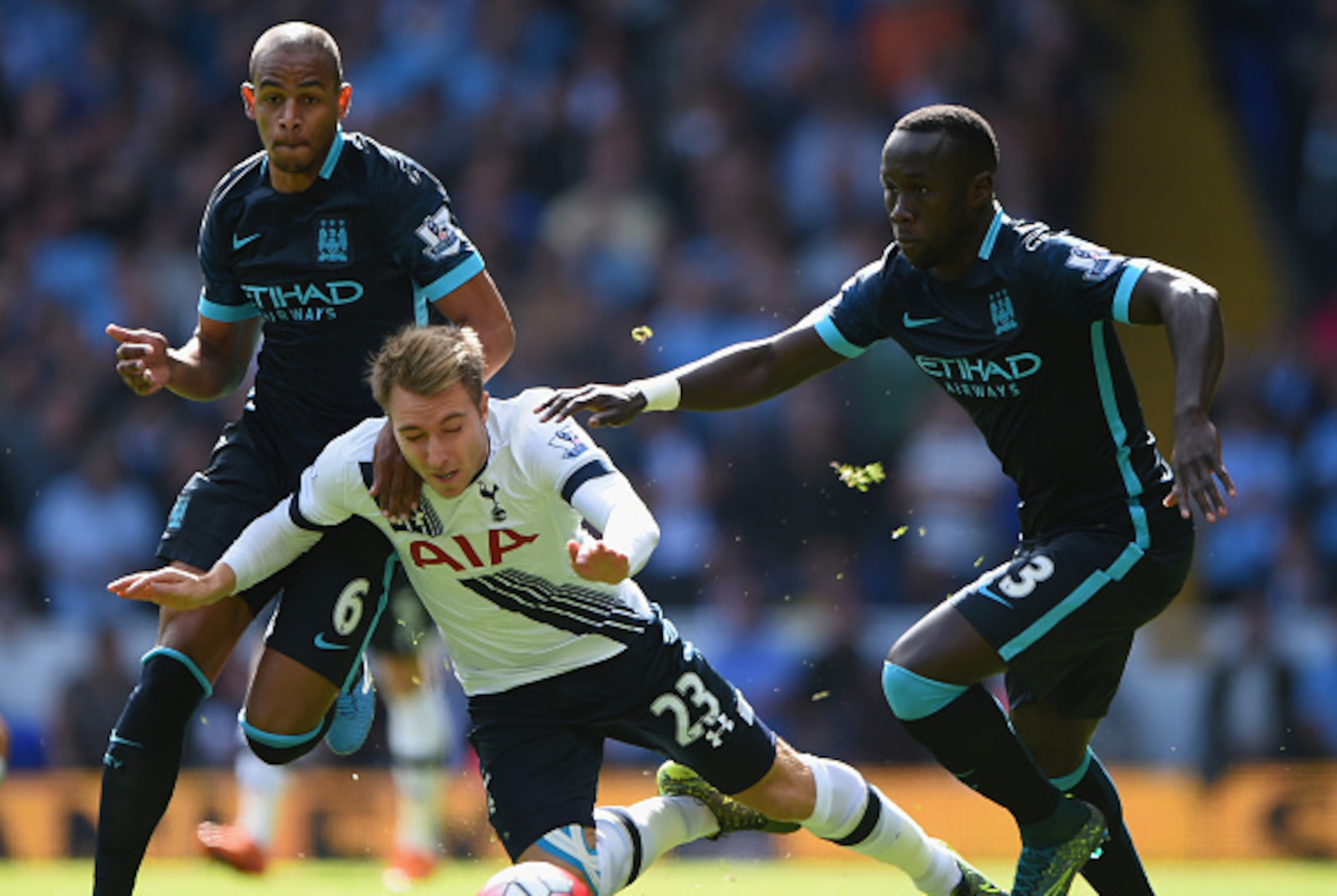 LONDON, ENGLAND - SEPTEMBER 26: Christian Eriksen (C) of Tottenham Hotspur is brought down by Fernando (L) and Bacary Sagna (R) of Manchester City  during the Barclays Premier League match between Tottenham Hotspur and Manchester City at White Hart Lane o