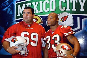 MEXICO CITY, MEXICO:  Cardinals player Rolando Cantu and Tony Parrish of San Francisco 49ers, pose for photographers during a press conference in Mexico City, 15 July 2005. The San Francisco 49ers and the Cardinals of Arizona will play the first regular s