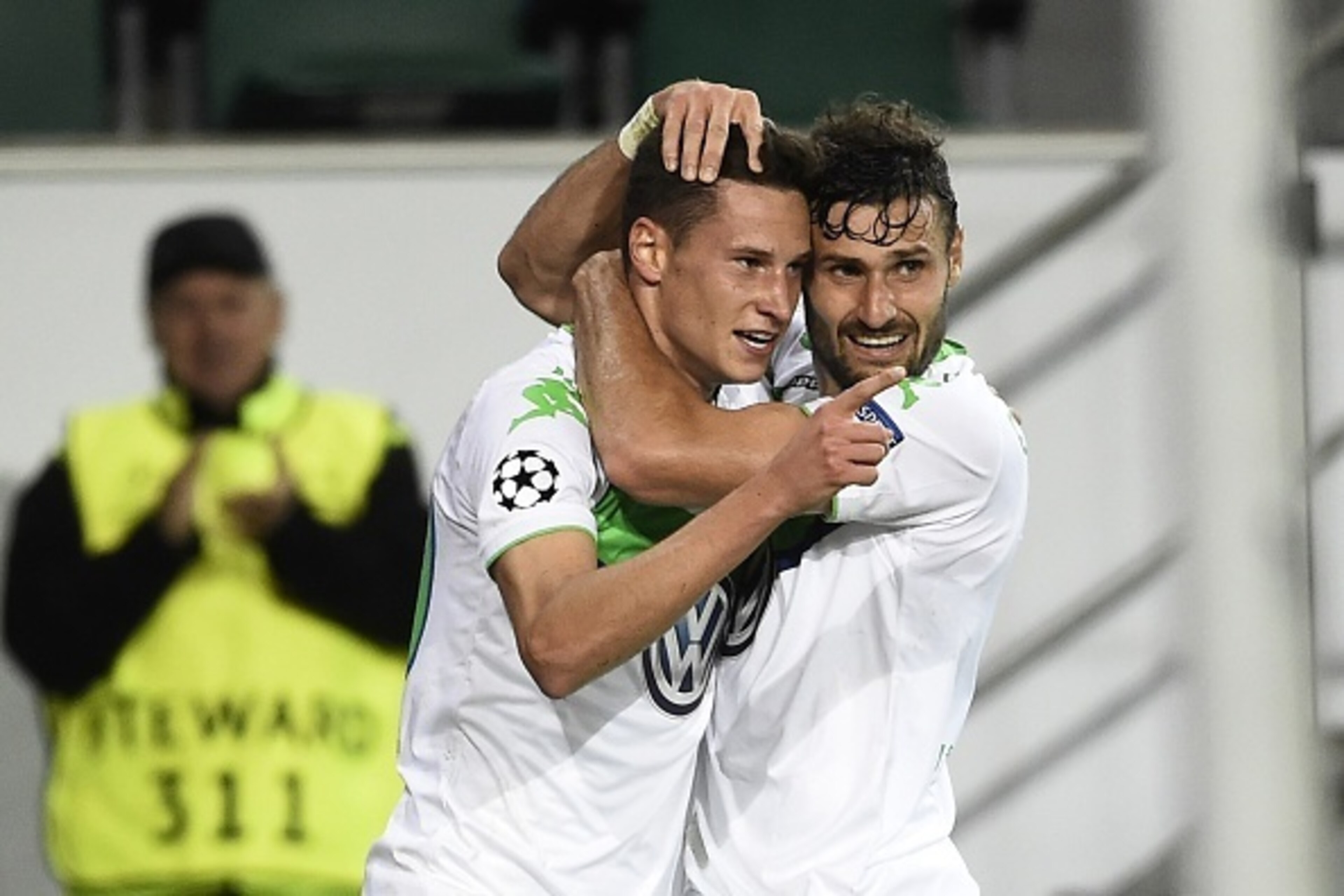 Wolfsburg's German midfielder Julian Draxler (2nd R) celebrates with his team mate German midfielder Daniel Caligiuri after Draxler scored 1-0 during the UEFA Champions League group B first leg football match between VfL Wolfsburg and CSKA Moscow in Wolfs Wolfsburg's German midfielder Julian Draxler (2nd R) celebrates with his team mate German midfielder Daniel Caligiuri after Draxler scored 1-0 during the UEFA Champions League group B first leg football match between VfL Wolfsburg and CSKA Moscow in Wolfs