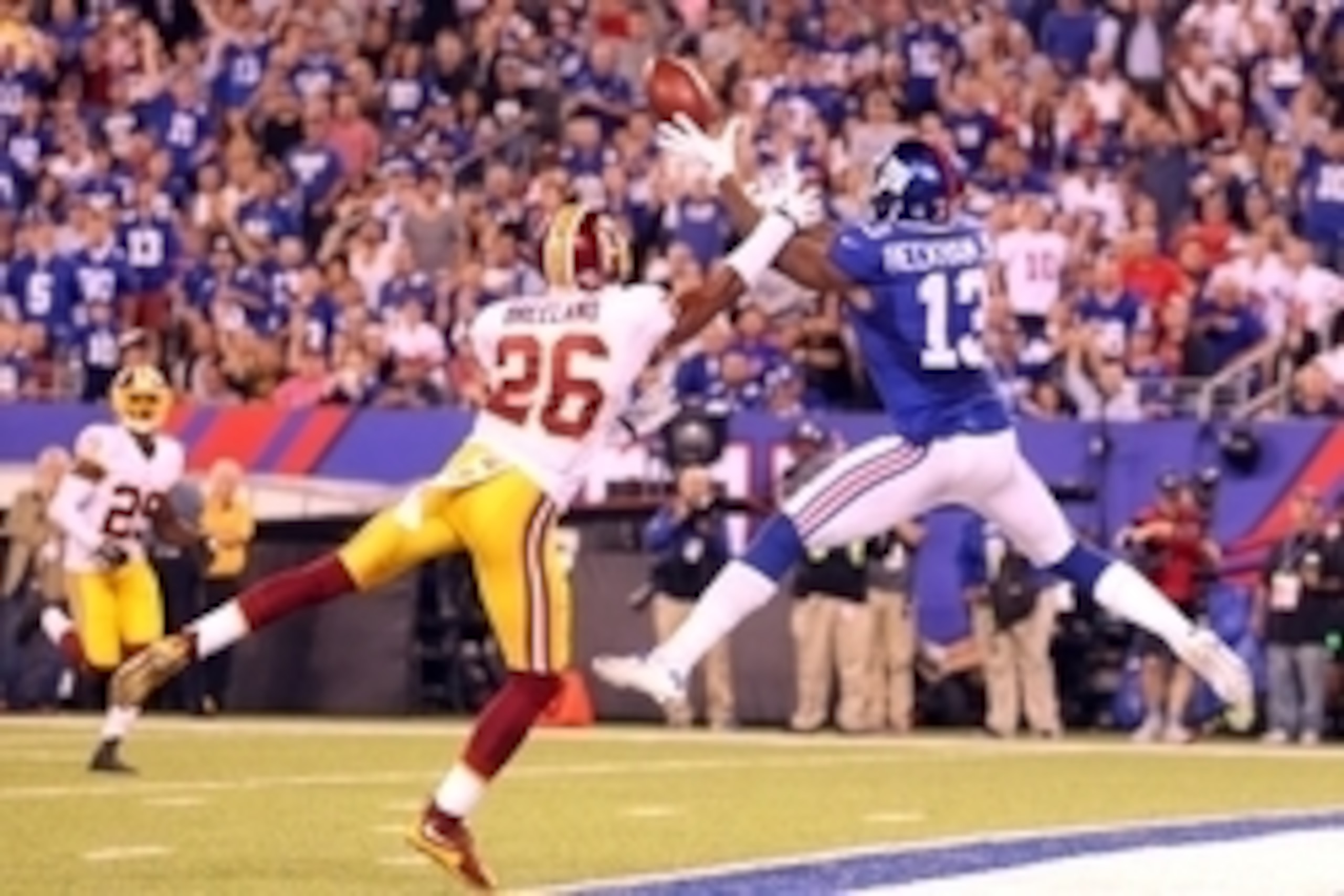 Sep 24, 2015; East Rutherford, NJ, USA; New York Giants wide receiver Odell Beckham Jr. (13) catches a touchdown pass in front of Washington Redskins corner back Bashaud Breeland (26) during the fourth quarter at MetLife Stadium. Mandatory Credit: Brad Pe