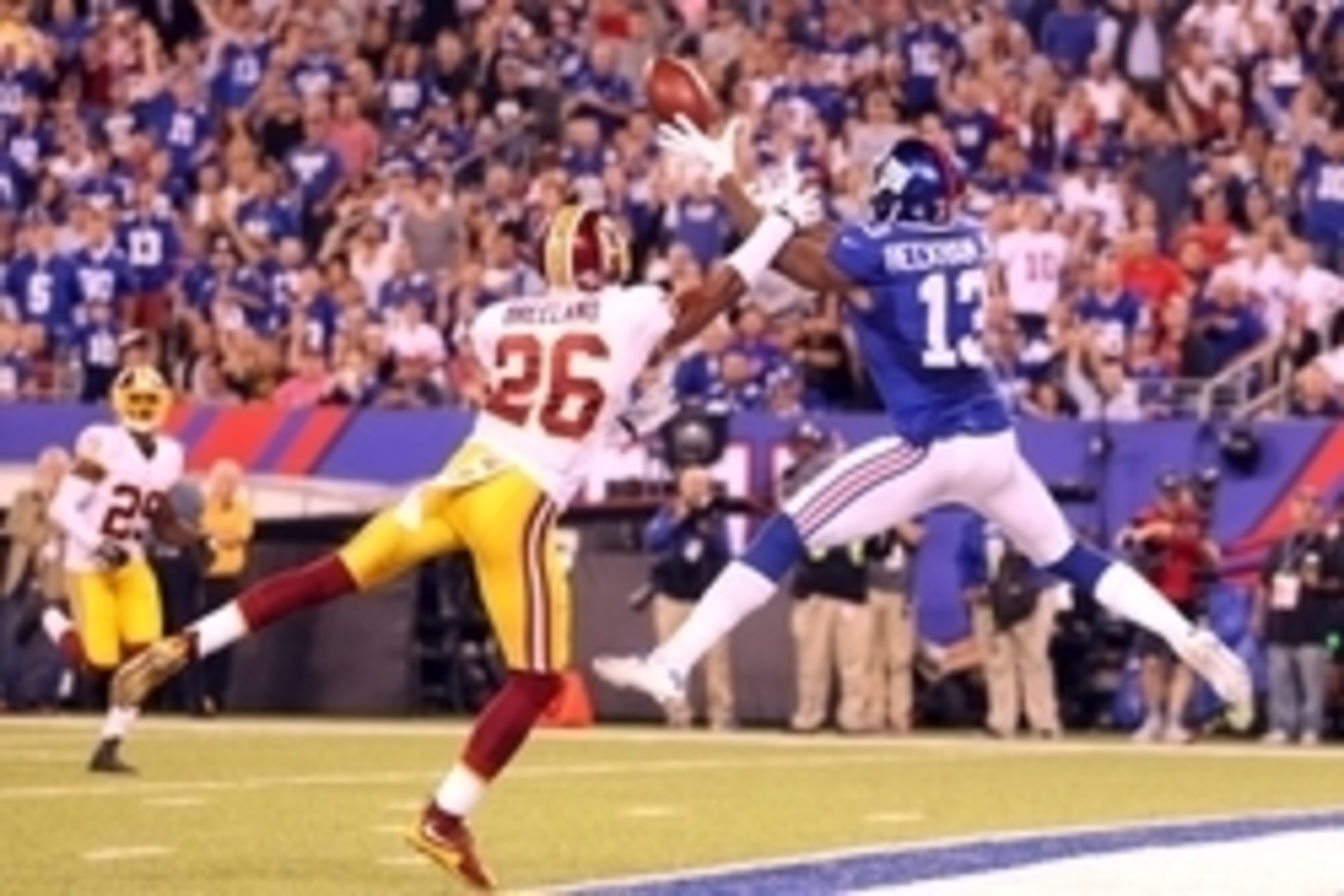 Sep 24, 2015; East Rutherford, NJ, USA; New York Giants wide receiver Odell Beckham Jr. (13) catches a touchdown pass in front of Washington Redskins corner back Bashaud Breeland (26) during the fourth quarter at MetLife Stadium. Mandatory Credit: Brad Pe