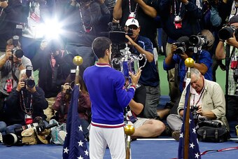 NEW YORK, NY - SEPTEMBER 13:  Novak Djokovic of Serbia celebrates with the winner's trophy after defeating Roger Federer of Switzerland during their Men's Singles Final match on Day Fourteen of the 2015 US Open at the USTA Billie Jean King National Tennis