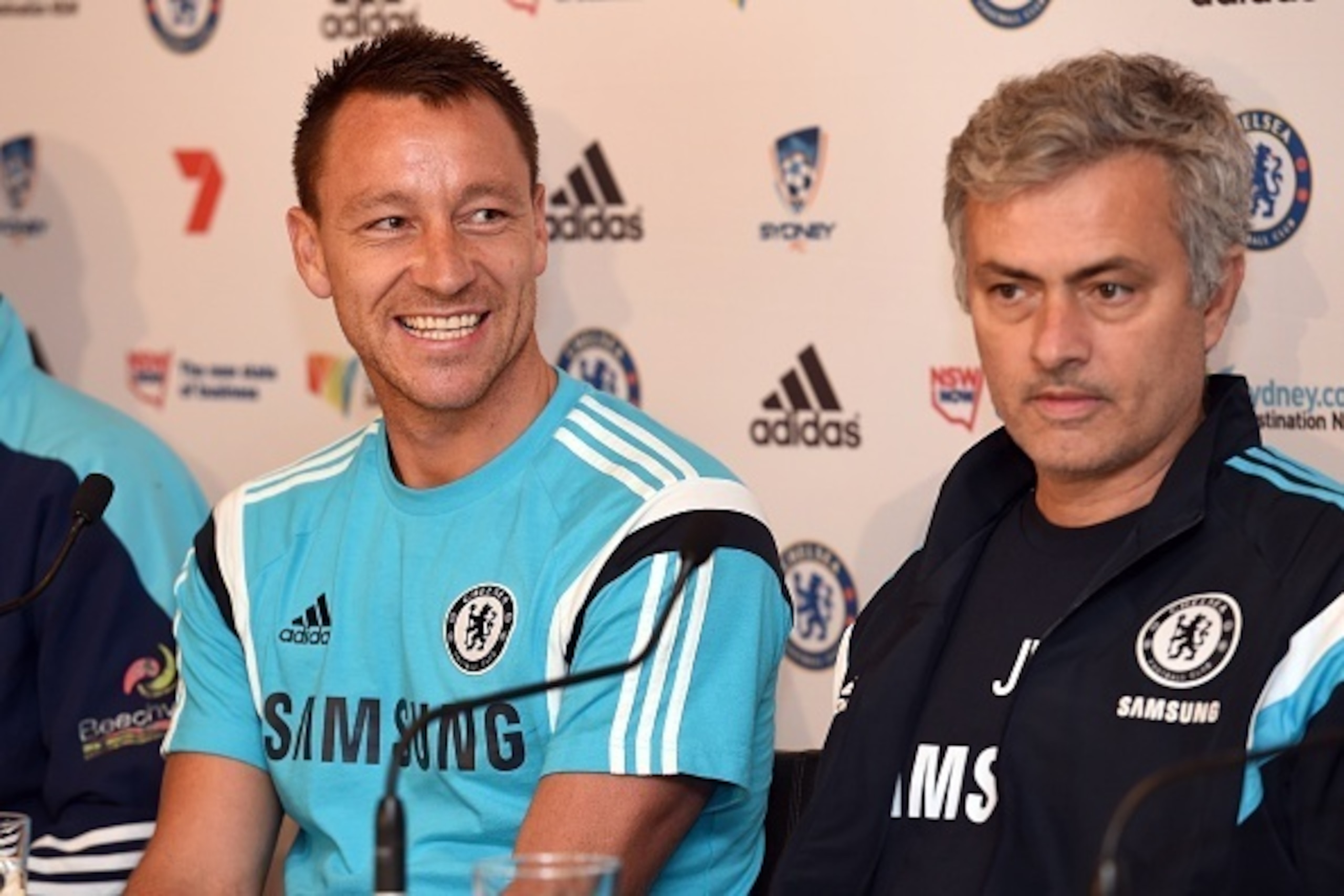 Chelsea football captain John Terry (L) smiles during a press conference with coach José Mourinho (R) after their arrival in Sydney on May 31, 2015.  The English Premier League champions take on local team Sydney FC on June 2.  AFP PHOTO/William WEST     