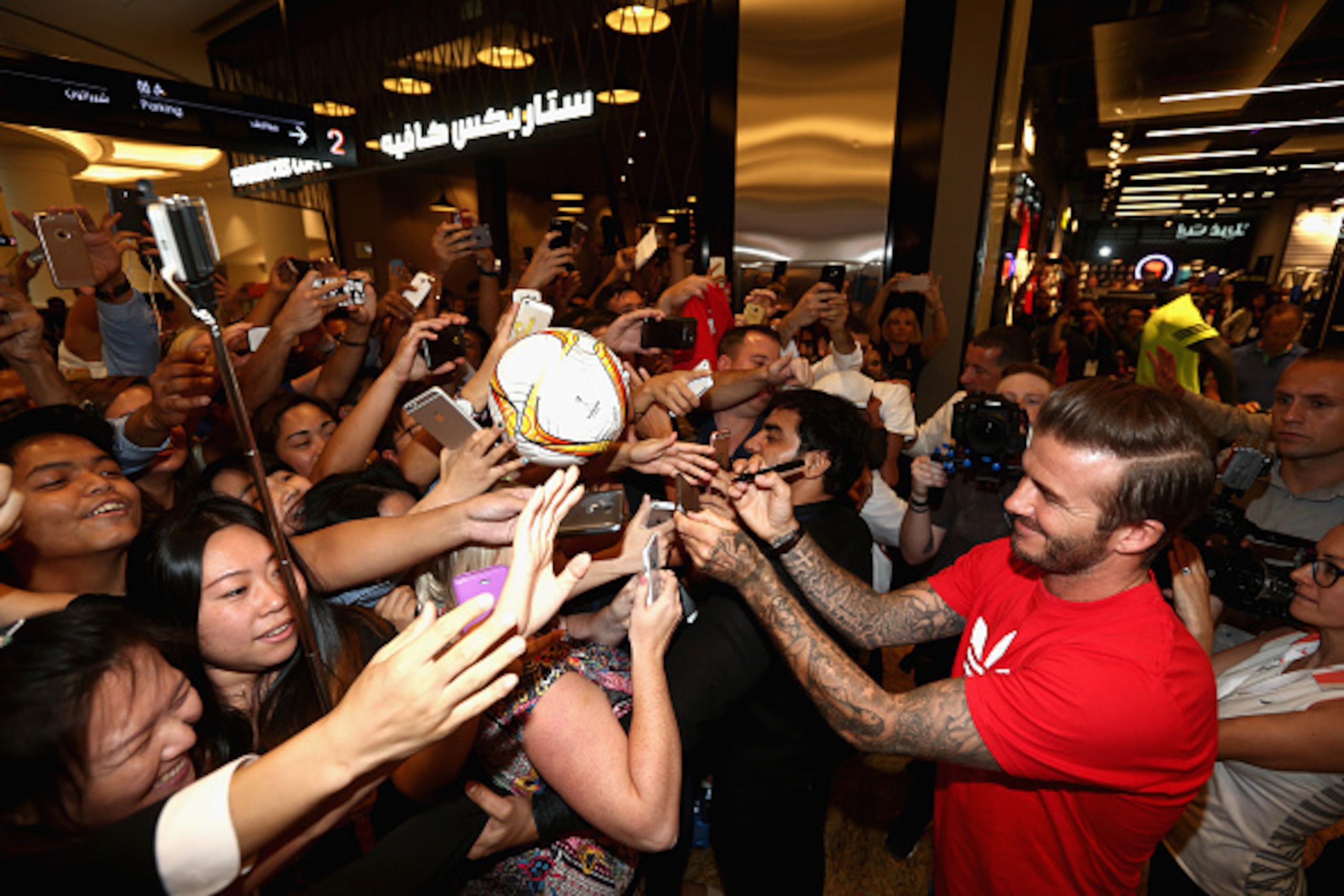 DUBAI, UNITED ARAB EMIRATES - SEPTEMBER 29:  Global icon and footballing legend David Beckham signs autographs as he opened the new adidas HomeCourt concept store in the Mall of Emirates, Dubai to the delight of thousands of fans who caught a glimpse of t