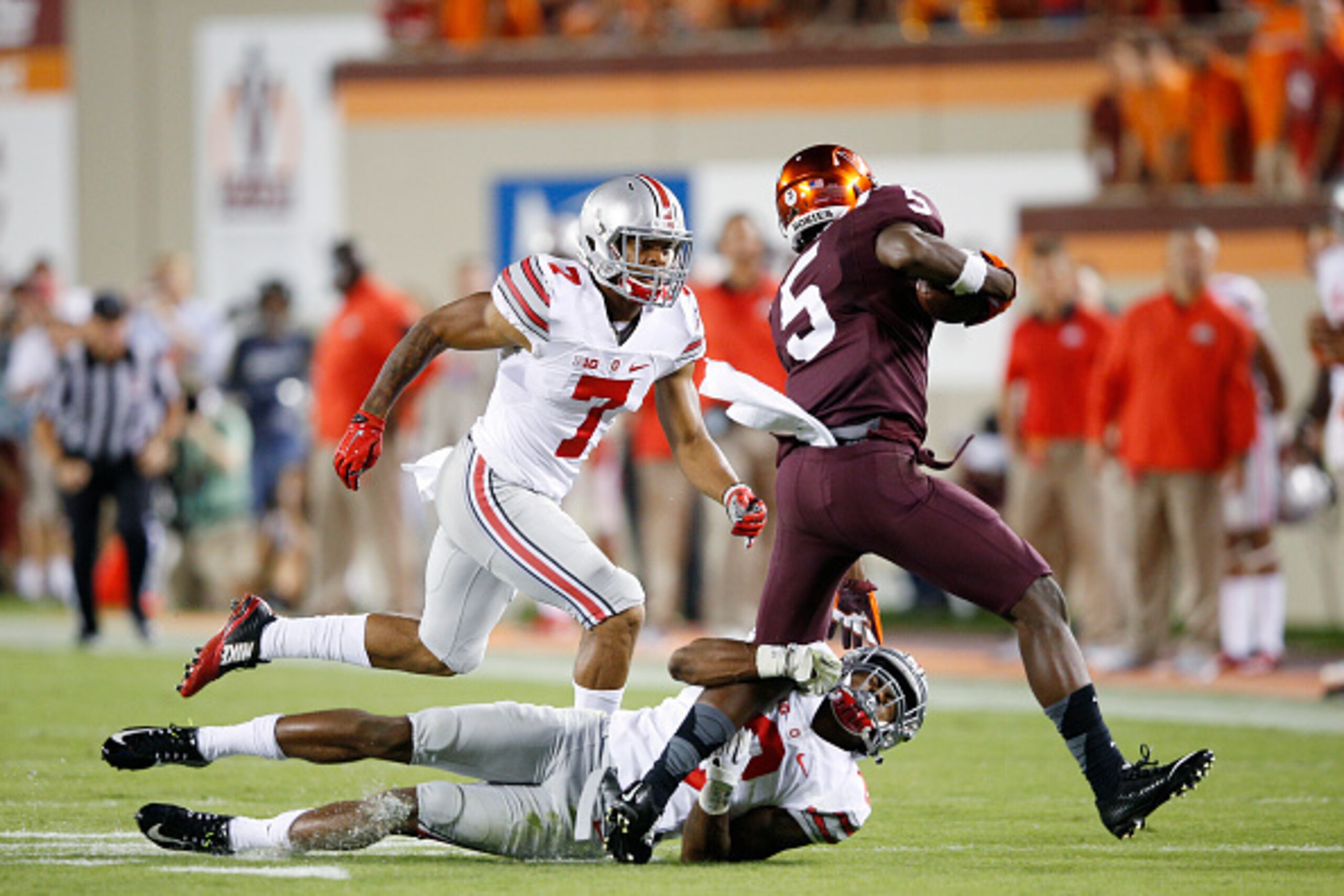 BLACKSBURG, VA - SEPTEMBER 7: Gareon Conley #8 and Damon Webb #7 of the Ohio State Buckeyes tackle Cam Phillips #5 of the Virginia Tech Hokies at Lane Stadium on September 7, 2015 in Blacksburg, Virginia. Ohio State defeated Virginia Tech 42-24. (Photo by