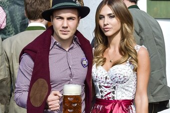 Bayern Munich's German midfielder Mario Goetze and his girlfriend Ann Kathrine Broemmel dressed in traditional Bavarian clothing visit the Oktoberfest venue in Munich, southern Germany, on September 30, 2015. AFP PHOTO / GUENTER SCHIFFMANN        (Photo c