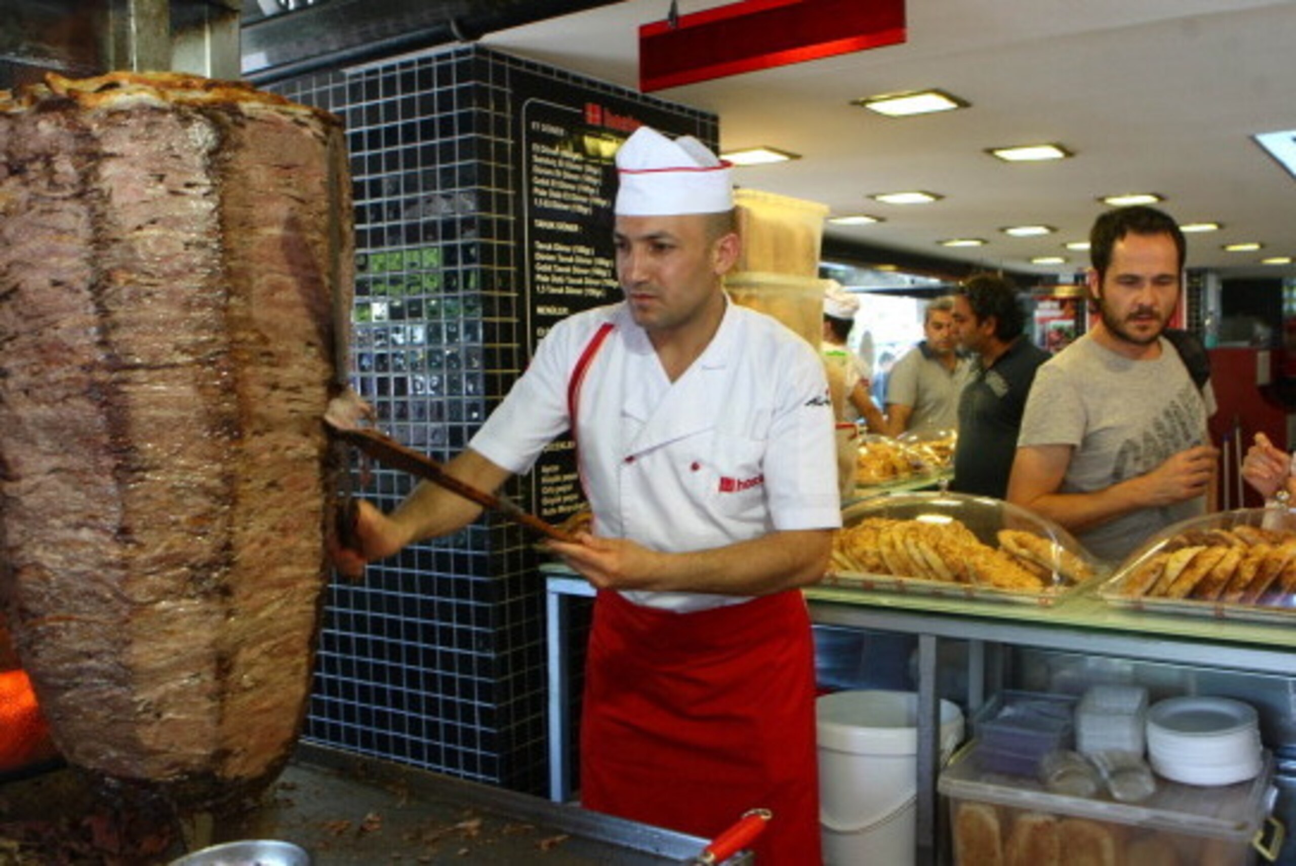 TO GO WITH AFP STORY BY BURAK AKINCI 
This photo taken on July 10, 2012, in Ankara shows people at a traditional 'doner' fast food restaurant. In Turkey 35% of the population has accumulated excess body fat to the extent that it may have an adverse effect