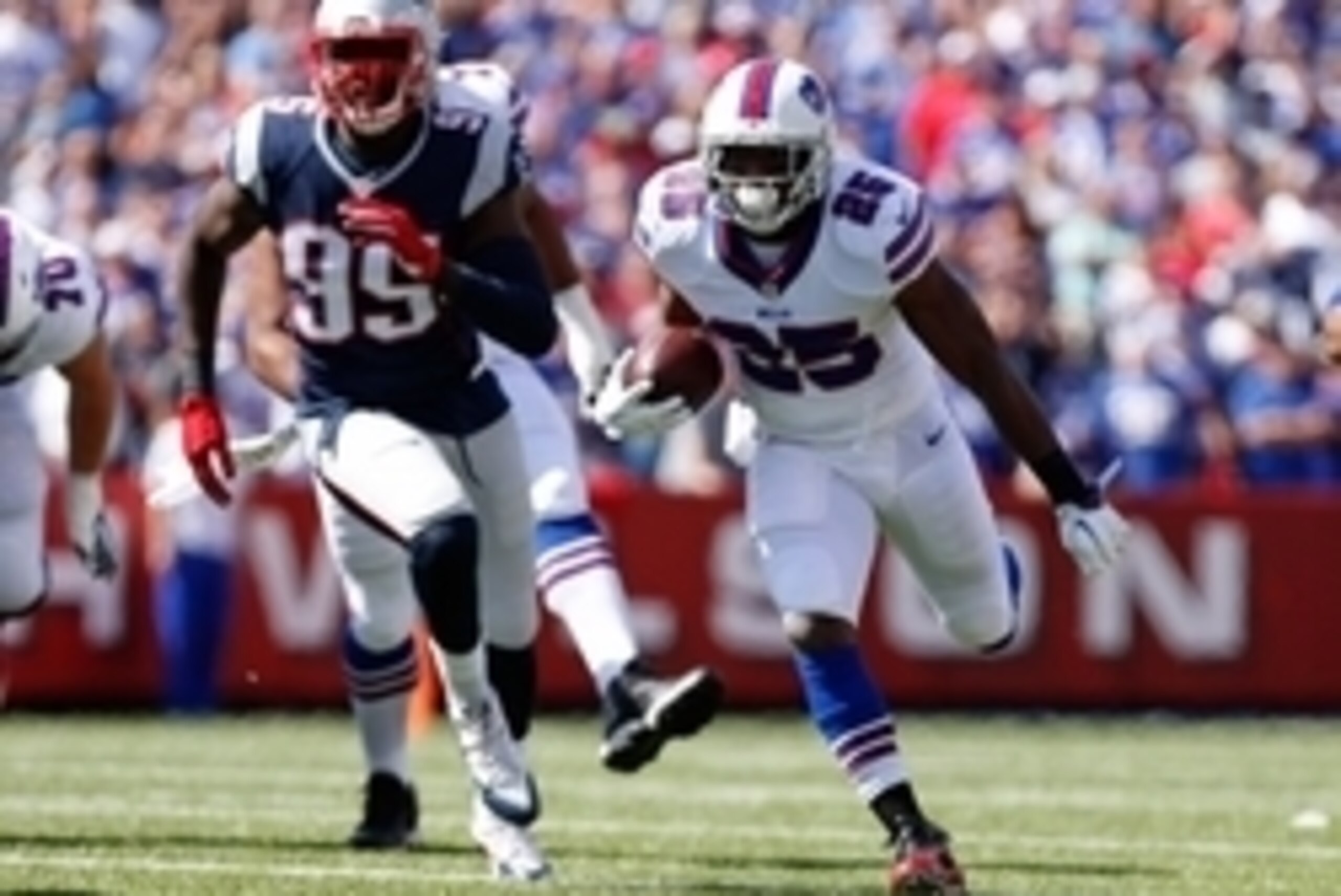 Sep 20, 2015; Orchard Park, NY, USA; Buffalo Bills running back LeSean McCoy (25) runs with the ball and New England Patriots defensive end Chandler Jones (95) pursues during the first quarter at Ralph Wilson Stadium. Mandatory Credit: Kevin Hoffman-USA T