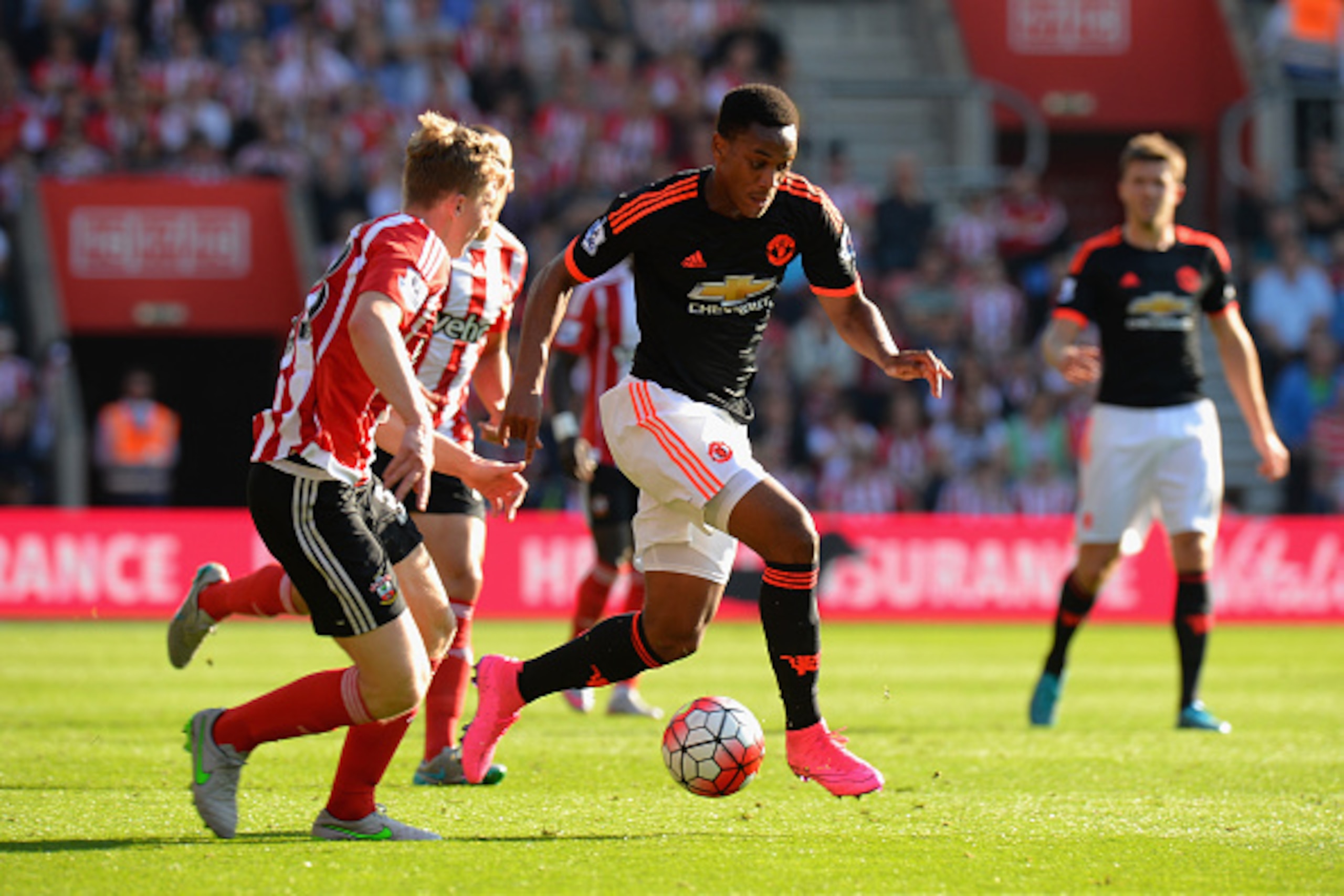 SOUTHAMPTON, ENGLAND - SEPTEMBER 20:  Anthony Martial of Manchester United gets past a tackle from Matt Targett of Southampton during the Barclays Premier League match between Southampton and Manchester United at St Mary's Stadium on September 20, 2015 in