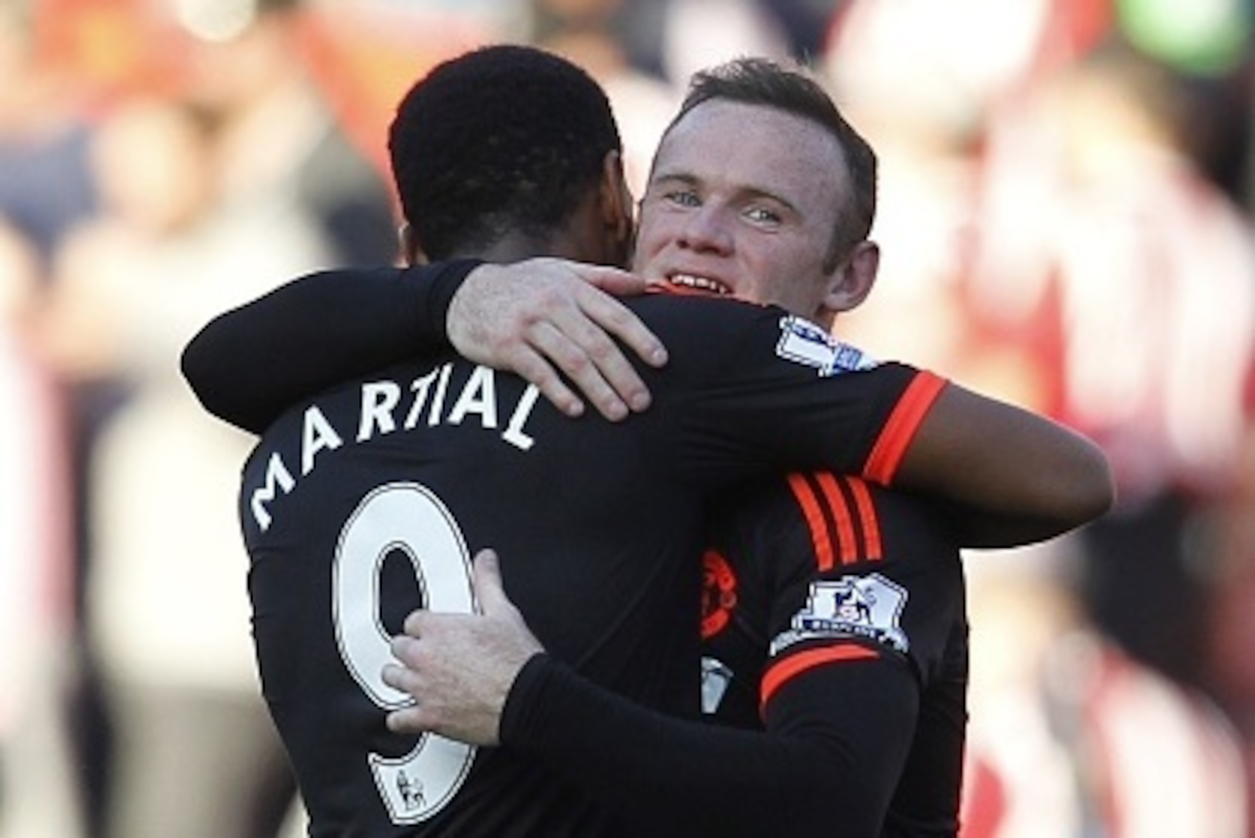 Manchester United's English striker Wayne Rooney embraces Manchester United's French striker Anthony Martial (L) after the English Premier League football match between Southampton and Manchester United at St Mary's Stadium in Southampton, southern Englan