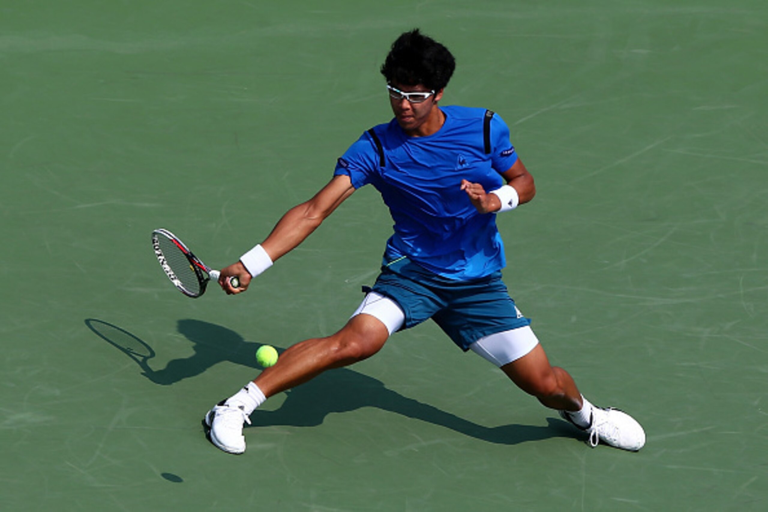 NEW YORK, NY - SEPTEMBER 03:  Hyeon Chung of Korea returns a shot against Stan Wawrinka of Switzerland during their Men's Singles Second Round match on Day Four of the 2015 US Open at the USTA Billie Jean King National Tennis Center on September 3, 2015 i