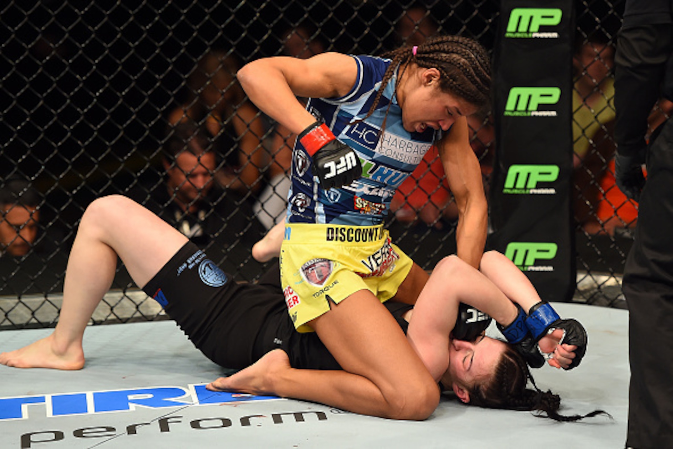 FAIRFAX, VA - APRIL 04:  (L-R) Juliana Pena punches Milana Dudieva on the ground in their women's bantamweight fight during the UFC Fight Night event at the Patriot Center on April 4, 2015 in Fairfax, Virginia. (Photo by Josh Hedges/Zuffa LLC/Zuffa LLC vi