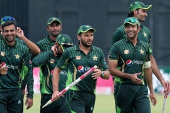 Pakistan players leave the pitch lead by captain Shahid Afridi after a series victory during the second of two T20 cricket matches between Pakistan and hosts Zimbabwe at Harare Sports Club,  on September 29, 2015. AFP/PHOTO JEKESAI NJIKIZANA        (Photo