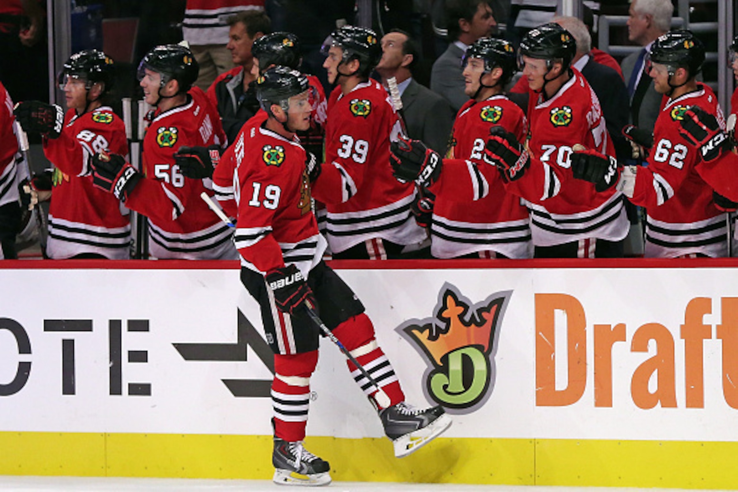CHICAGO, IL - SEPTEMBER 22: Jonathan Toews #19 of the Chicago Blackhawks is congratulated by teammates after scoring a 1st period goal against the Detroit Red Wings during a preseason game at the United Center on September 22, 2015 in Chicago, Illinois. CHICAGO, IL - SEPTEMBER 22: Jonathan Toews #19 of the Chicago Blackhawks is congratulated by teammates after scoring a 1st period goal against the Detroit Red Wings during a preseason game at the United Center on September 22, 2015 in Chicago, Illinois.