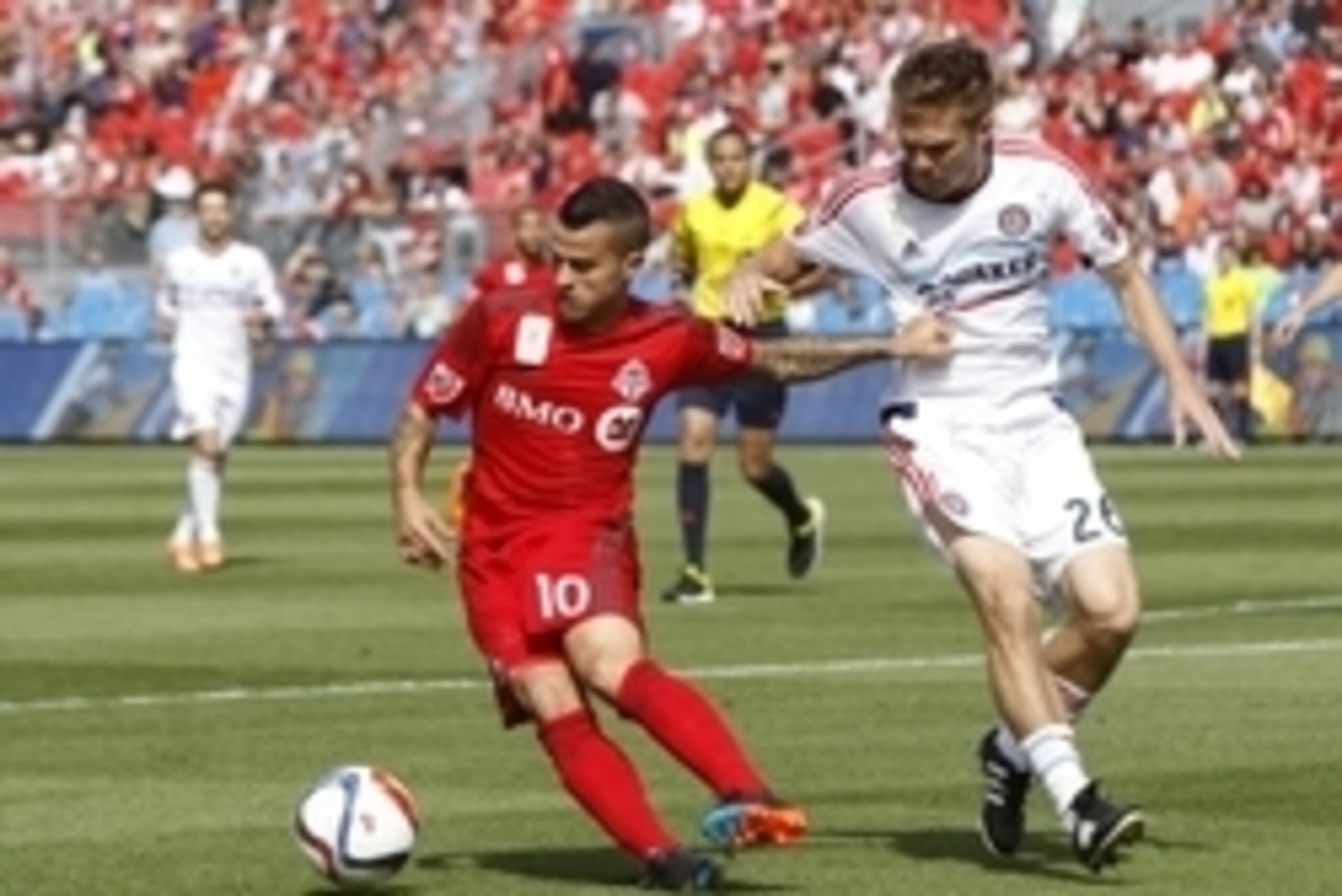 Sep 26, 2015; Toronto, Ontario, CAN; Toronto FC forward Sebastian Giovinco (10) tries to get away from Chicago Fire midfielder Michael Stephens (26) during the first half at BMO Field. Mandatory Credit: John E. Sokolowski-USA TODAY Sports Sep 26, 2015; Toronto, Ontario, CAN; Toronto FC forward Sebastian Giovinco (10) tries to get away from Chicago Fire midfielder Michael Stephens (26) during the first half at BMO Field. Mandatory Credit: John E. Sokolowski-USA TODAY Sports