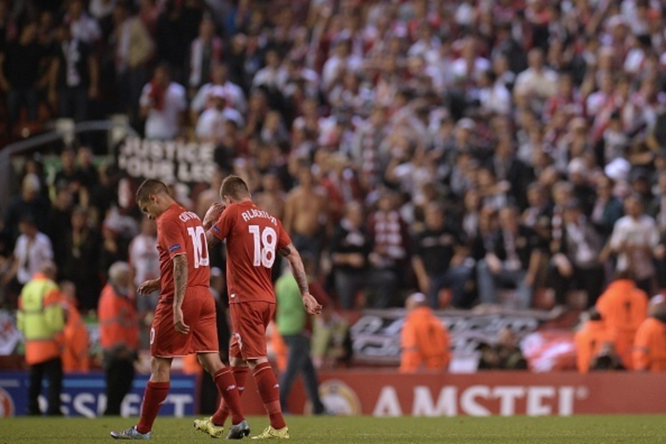 Liverpool's Brazilian midfielder Philippe Coutinho (L) and Liverpool's Spanish defender Alberto Moreno react as they leave the pitch after the UEFA Europa League group B football match between Liverpool and FC Sion at Anfield in Liverpool, north west Engl