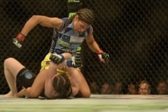 Apr 4, 2015; Fairfax, VA, USA; Julianna Pena (red gloves) fights Milana Dudieva (blue gloves) during UFC Fight Night at Patriot Center. Mandatory Credit: Tommy Gilligan-USA TODAY Sports