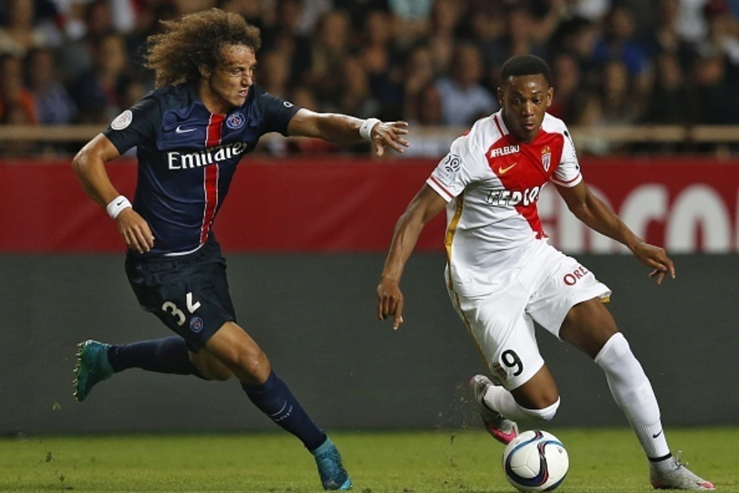 Paris Saint-Germain's Brazilian defender David Luiz (L) vies with Monaco's French forward Anthony Martial during the French L1 football match Monaco (ASM) vs Paris Saint-Germain (PSG), on August 30, 2015 at the Louis II stadium in Monaco.   AFP PHOTO / VA