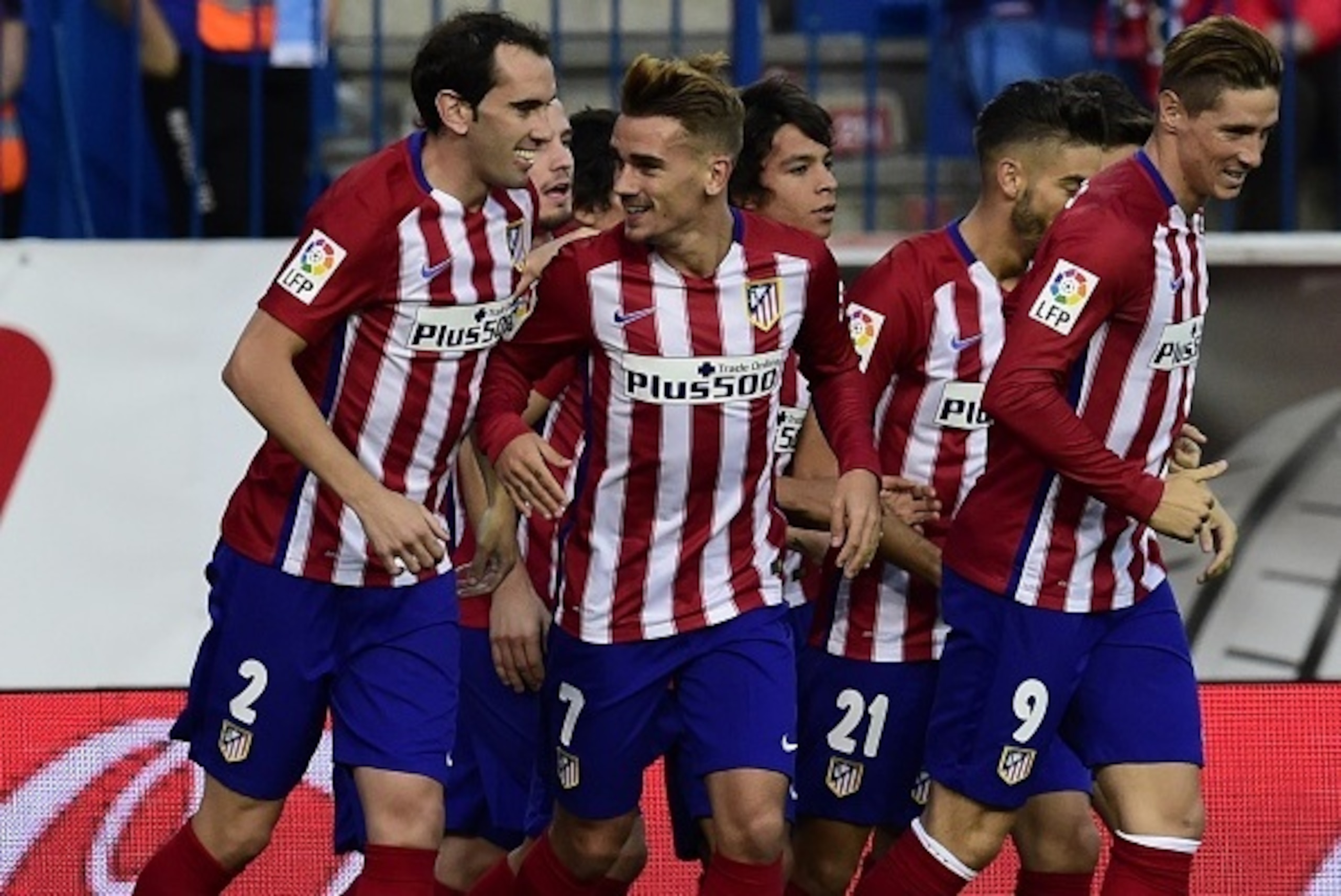 Atletico Madrid's French forward Antoine Griezmann (C) celebrates with Atletico Madrid's Uruguayan defender Diego Godin (L) and Atletico Madrid's forward Fernando Torres (R) after scoring a goal during the Spanish league football match Club Atletico de Ma