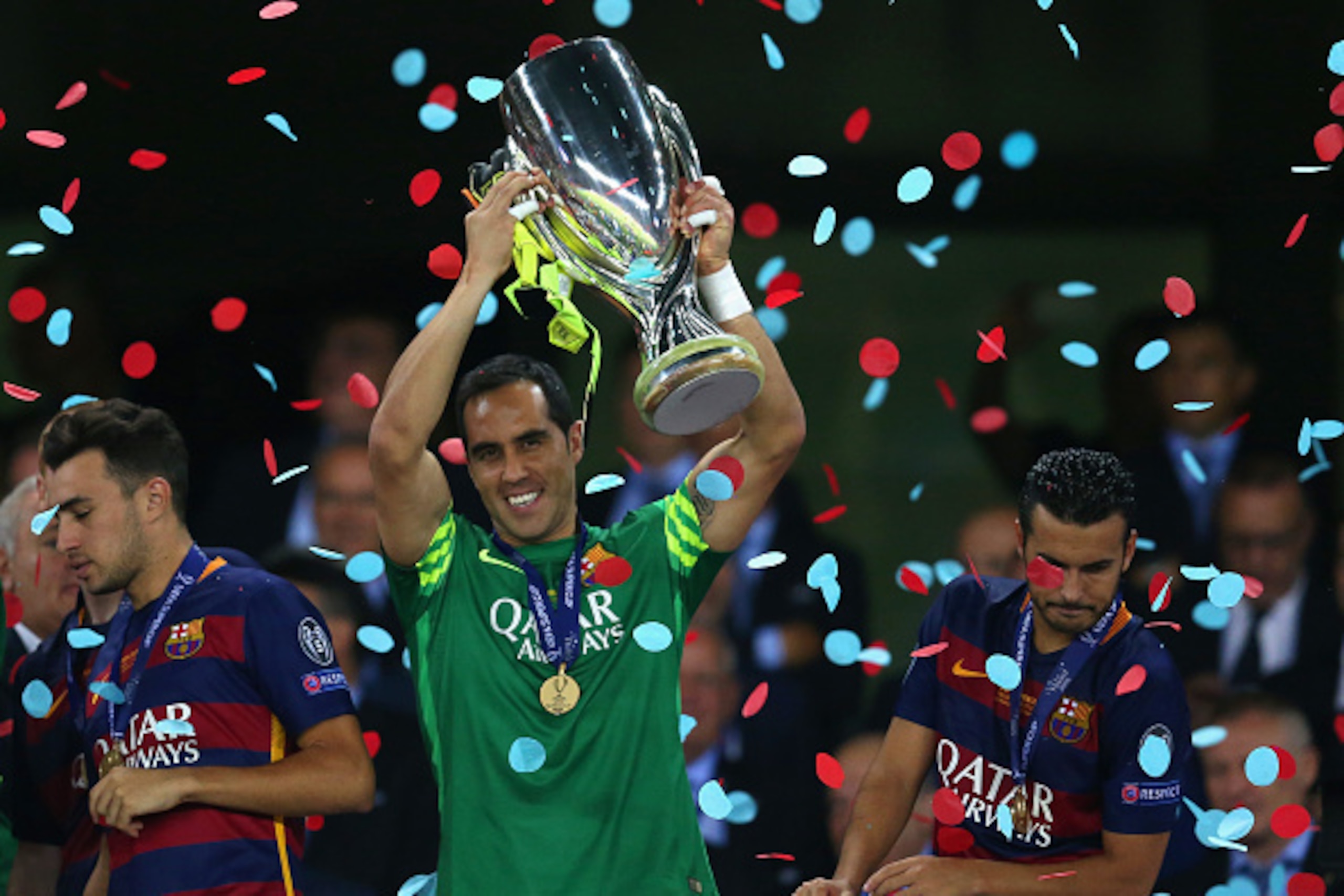 TBILISI, GEORGIA - AUGUST 11: Claudio Bravo of Barcelona lifts the trophy as Pedro of Barcelona (R) looks over the balcony during the UEFA Super Cup between Barcelona and Sevilla FC at Dinamo Arena on August 11, 2015 in Tbilisi, Georgia.  (Photo by Chris 