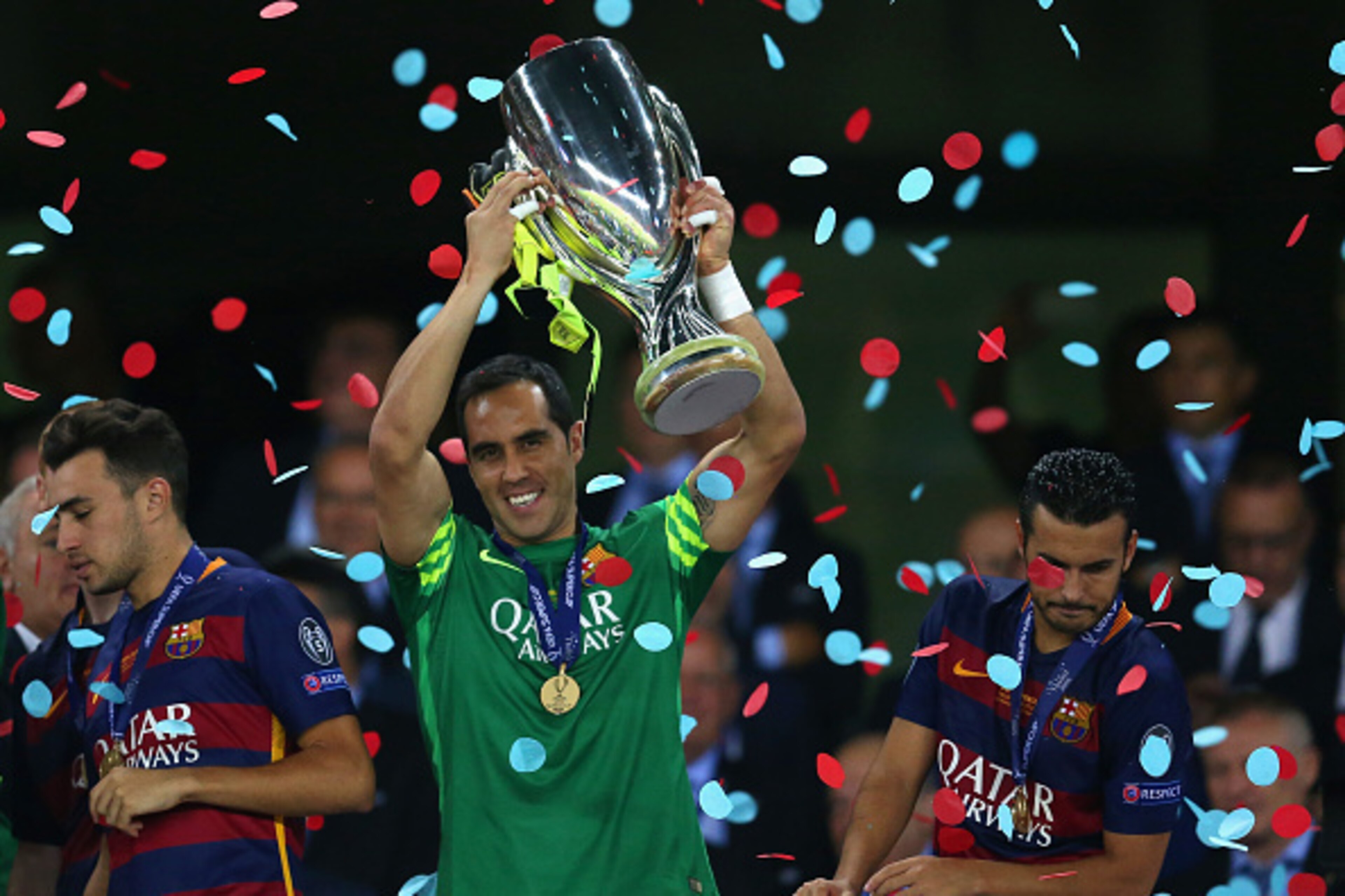 TBILISI, GEORGIA - AUGUST 11: Claudio Bravo of Barcelona lifts the trophy as Pedro of Barcelona (R) looks over the balcony during the UEFA Super Cup between Barcelona and Sevilla FC at Dinamo Arena on August 11, 2015 in Tbilisi, Georgia.  (Photo by Chris 