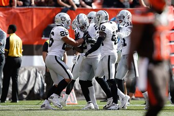 CLEVELAND, OH - SEPTEMBER 27:  Charles Woodson #24 of the Oakland Raiders celebrates with teammates after intercepting a pass during the fourth quarter against the Cleveland Browns at FirstEnergy Stadium on September 27, 2015 in Cleveland, Ohio.  (Photo b