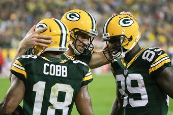 GREEN BAY, WI - SEPTEMBER 28:  Quarterback  Aaron Rodgers #12 of the Green Bay Packers celebrates with  Randall Cobb #18 and  James Jones #89 after scoring against the Kansas City Chiefs in the third quarter at Lambeau Field on September 28, 2015 in Green