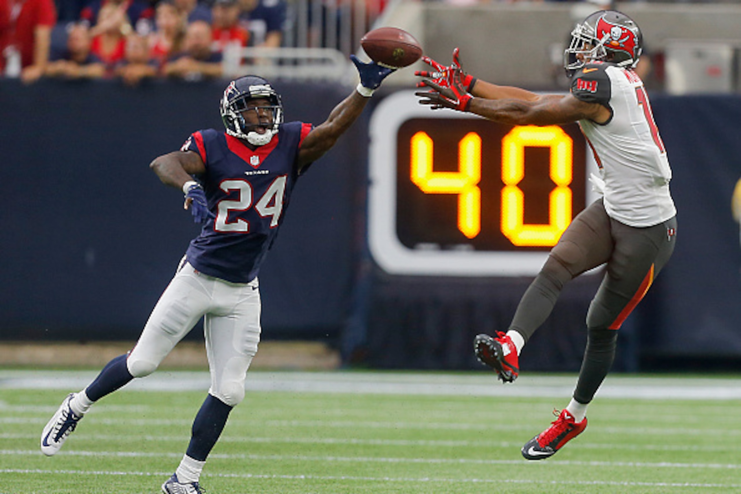 HOUSTON, TX - SEPTEMBER 27: Johnathan Joseph #24 of the Houston Texans knock2s the ball away from Cameron Bates #84 of the Tampa Bay Buccaneers in the second quarter at NRG Stadium on September 27, 2015 in Houston, Texas. (Photo by Bob Levey/Getty Image HOUSTON, TX - SEPTEMBER 27: Johnathan Joseph #24 of the Houston Texans knock2s the ball away from Cameron Bates #84 of the Tampa Bay Buccaneers in the second quarter at NRG Stadium on September 27, 2015 in Houston, Texas. (Photo by Bob Levey/Getty Image