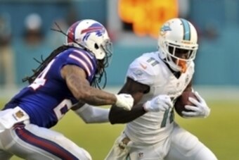 Sep 27, 2015; Miami Gardens, FL, USA; Miami Dolphins wide receiver DeVante Parker (11) is tackled by Buffalo Bills cornerback Stephon Gilmore (24) during the second half at Sun Life Stadium. Mandatory Credit: Steve Mitchell-USA TODAY Sports