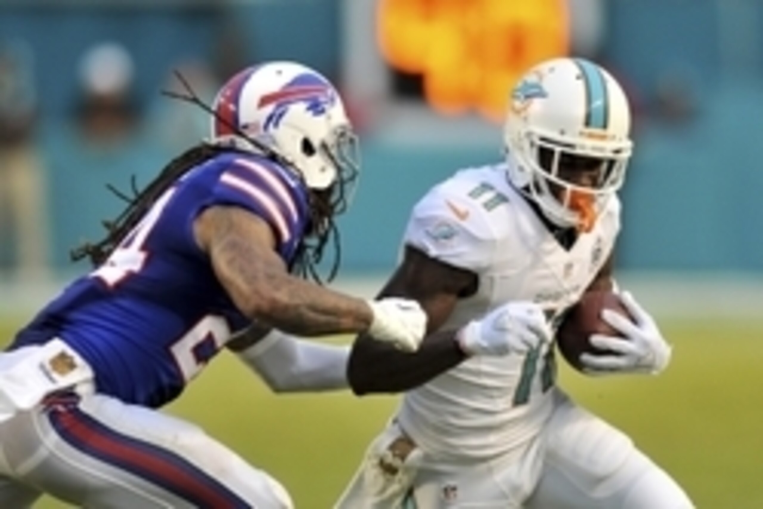 Sep 27, 2015; Miami Gardens, FL, USA; Miami Dolphins wide receiver DeVante Parker (11) is tackled by Buffalo Bills cornerback Stephon Gilmore (24) during the second half at Sun Life Stadium. Mandatory Credit: Steve Mitchell-USA TODAY Sports