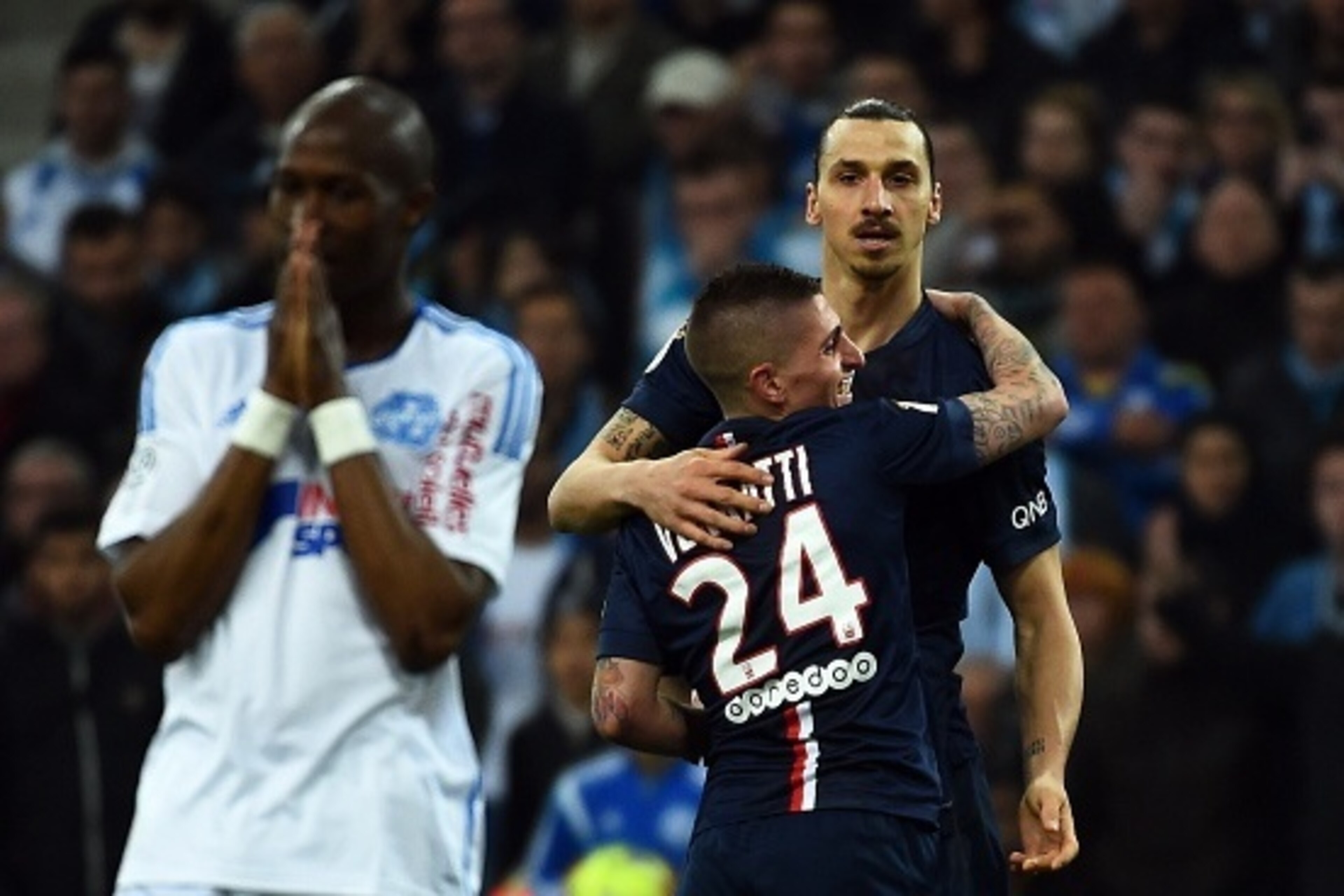 Paris Saint Germain Swedish forward Zlatan Ibrahimovic (R) celebrates after scoring a goal  during the French L1 football match between Marseille (OM) and Paris Saint Germain (PSG) at the Velodrome stadium in Marseille, southern France, on April 5, 2015. 