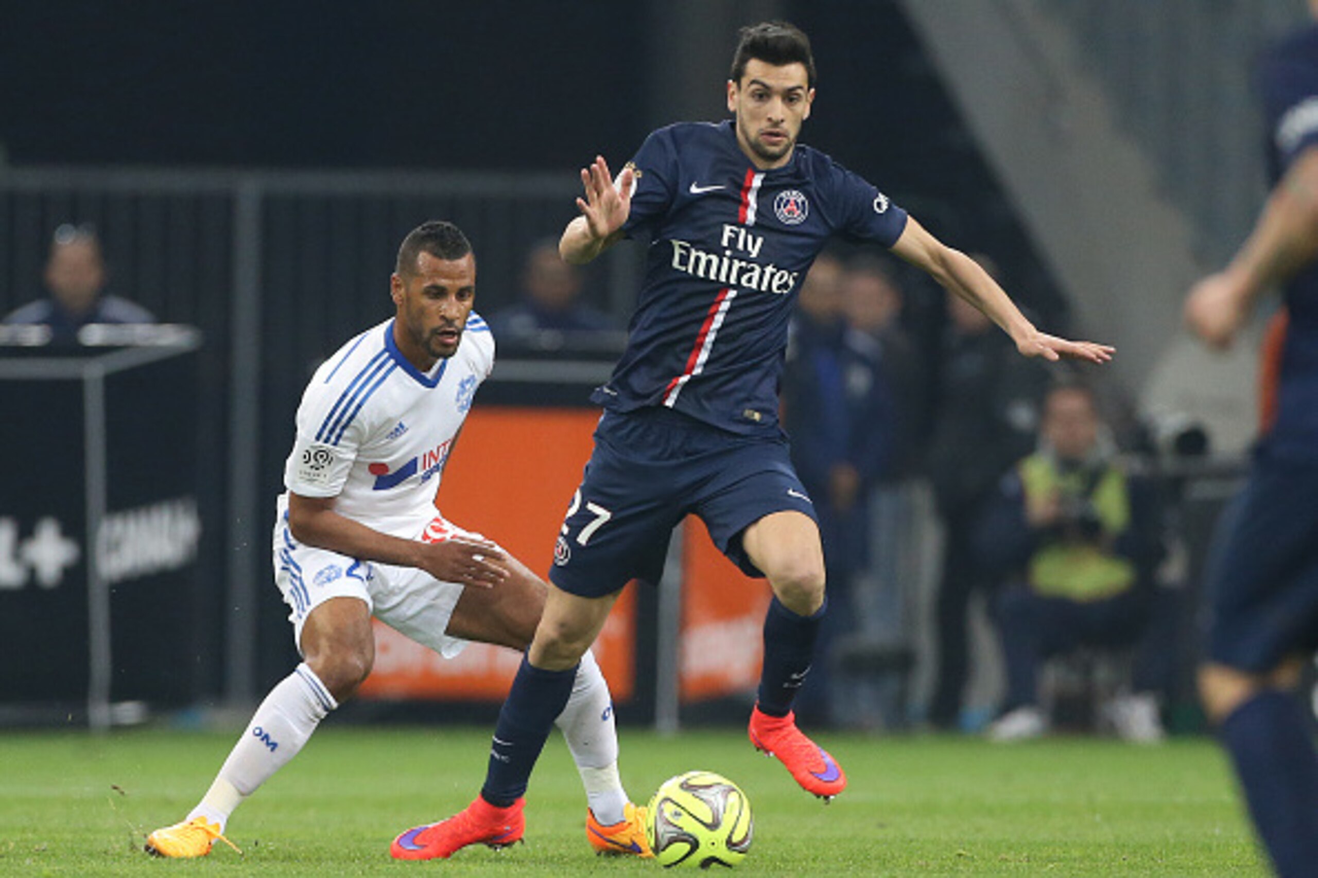 MARSEILLE, FRANCE - APRIL 5: Javier Pastore of PSG and Jacques-Alaixys Romao of OM (left) in action during the French Ligue 1 match between Olympique de Marseille (OM) and Paris Saint-Germain (PSG) at New Stade Velodrome on April 5, 2015 in Marseille, Fra