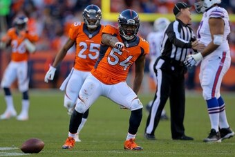 DENVER, CO - DECEMBER 7:  Outside linebacker Brandon Marshall #54 of the Denver Broncos celebrates his third quarter interception against the Buffalo Bills at Sports Authority Field Field at Mile High on December 7, 2014 in Denver, Colorado. The Broncos d