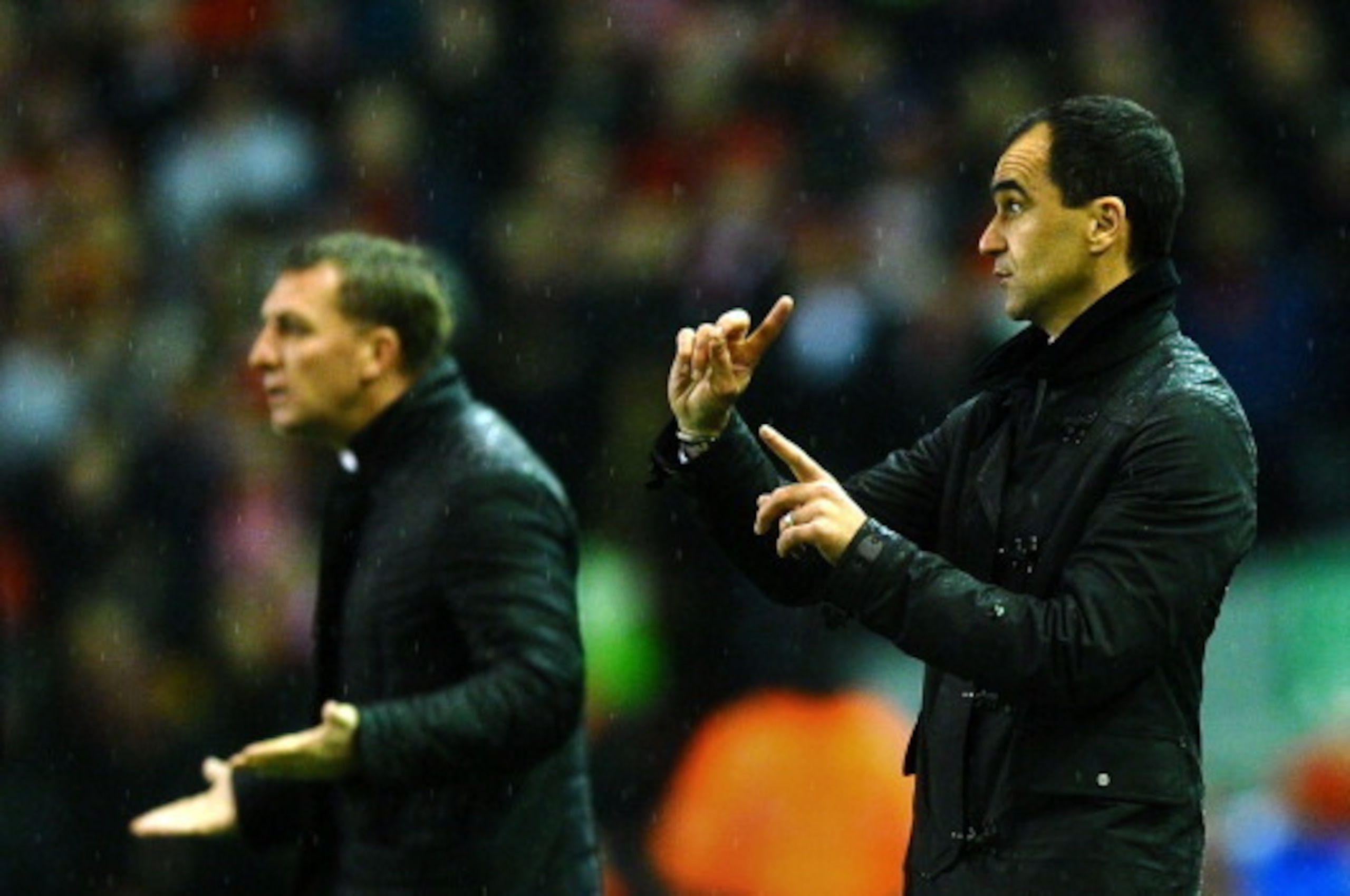 LIVERPOOL, ENGLAND - JANUARY 28:  Roberto Martinez the Everton manager directs his players as Brendan Rodgers the Liverpool manager reacts during the Barclays Premier League match between Liverpool and Everton at Anfield on January 28, 2014 in Liverpool, 